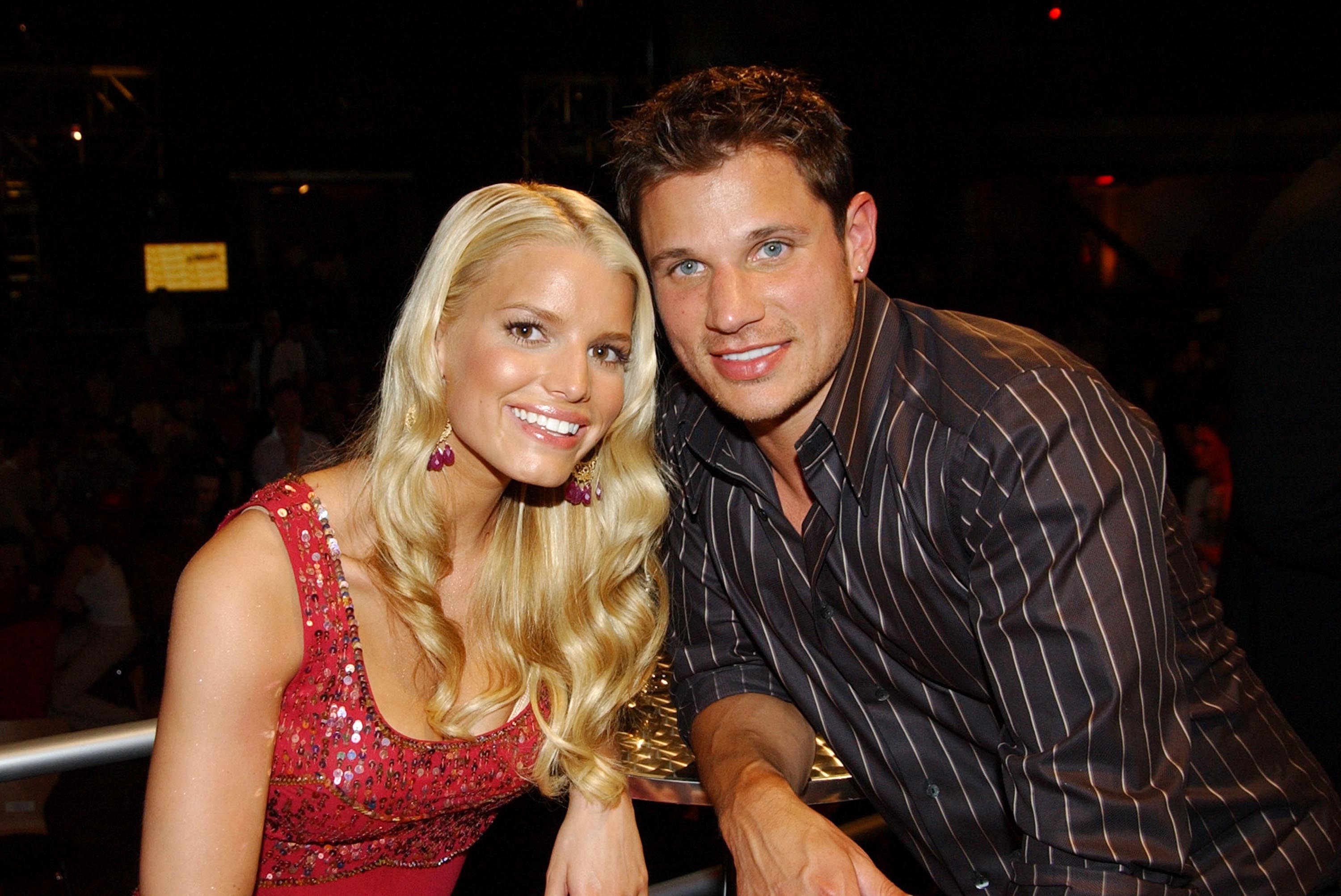 Jessica Simpson and Nick Lachey smiling for photo backstage at an MTV party