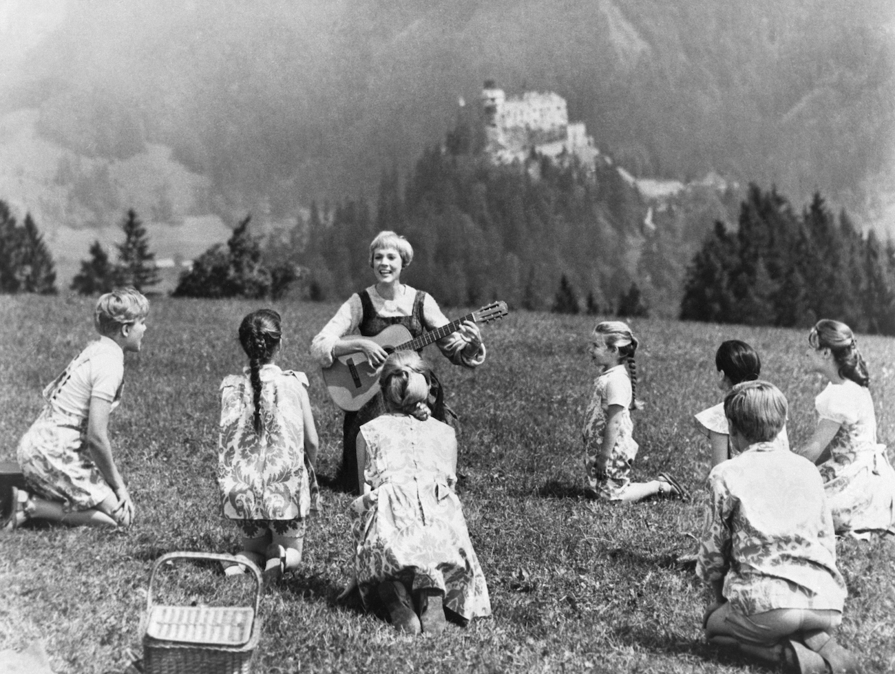 Sound of Music scene with Julie Andrews and children singing in a field