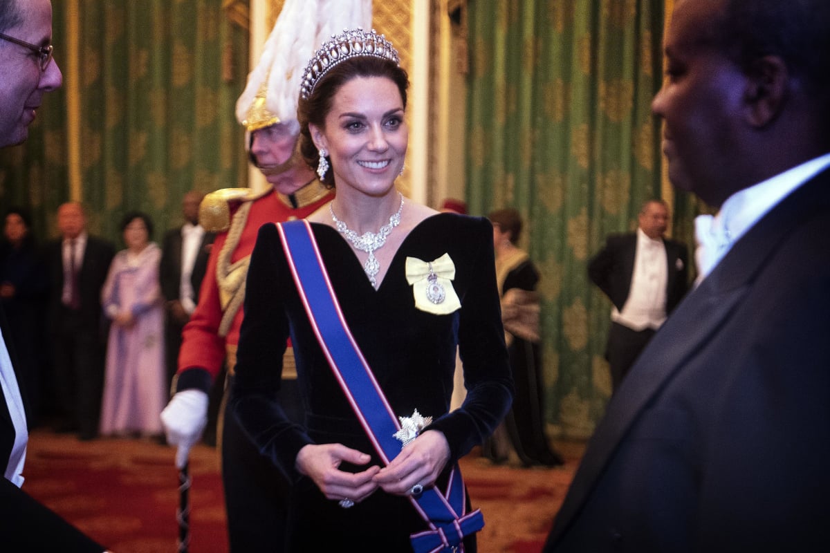 Kate Middleton talks to guests at an evening reception for members of the Diplomatic Corps at Buckingham Palace on December 11, 2019