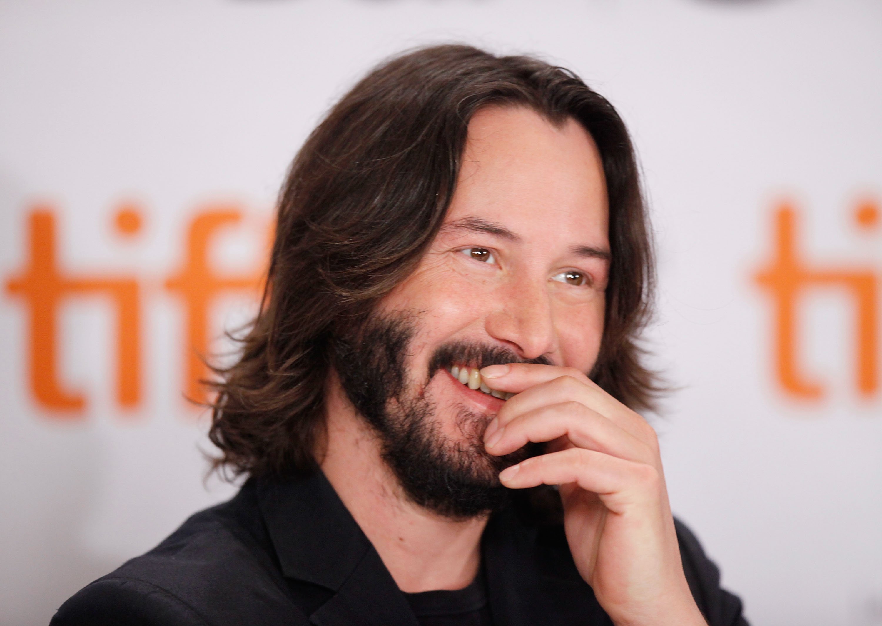 Keanu Reeves laughs at the Toronto Film Festival