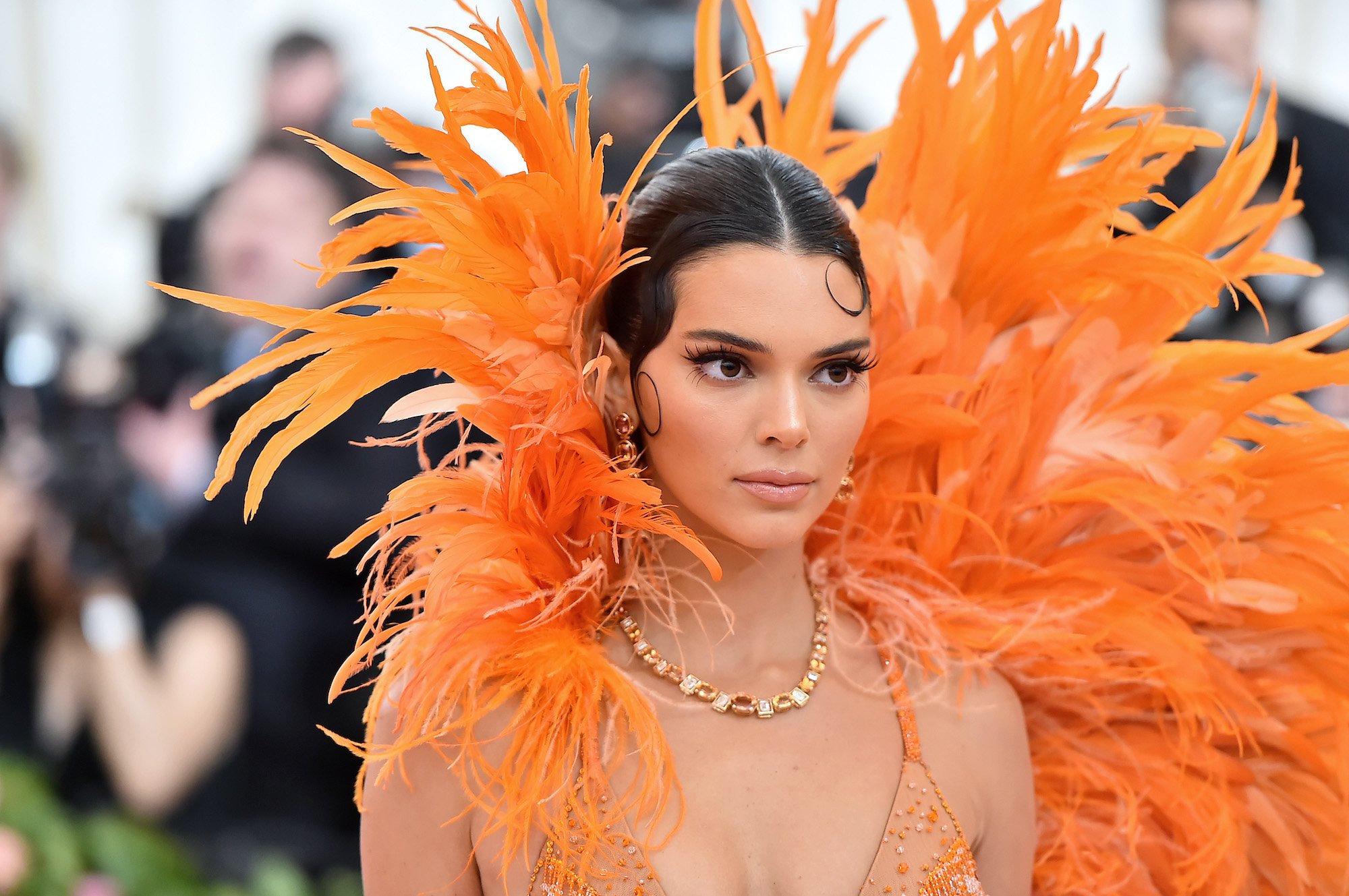 Kendall Jenner wearing an orange headdress