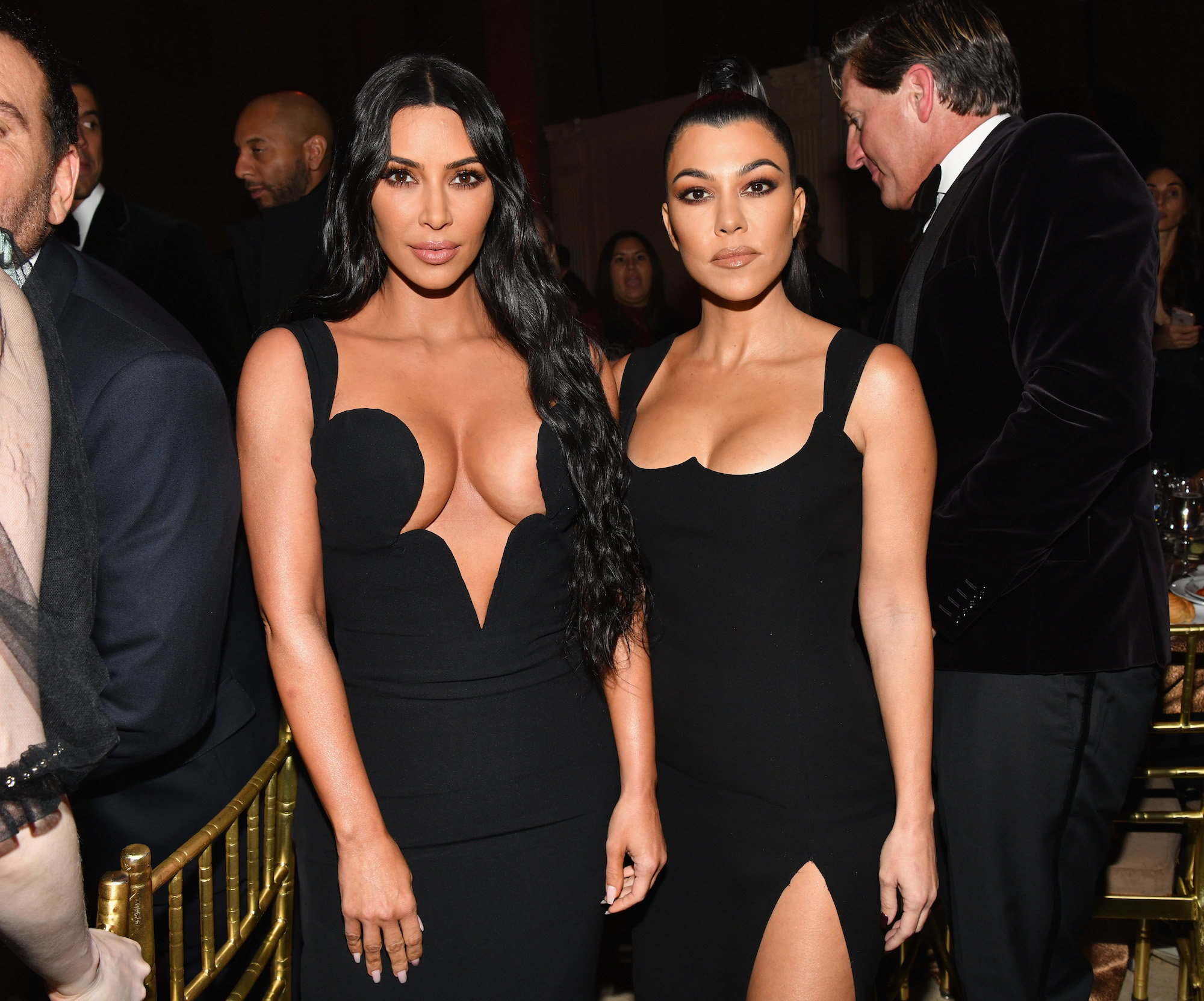 Kim Kardashian West and Kourtney Kardashian attending amfAR New York Gala in 2019
