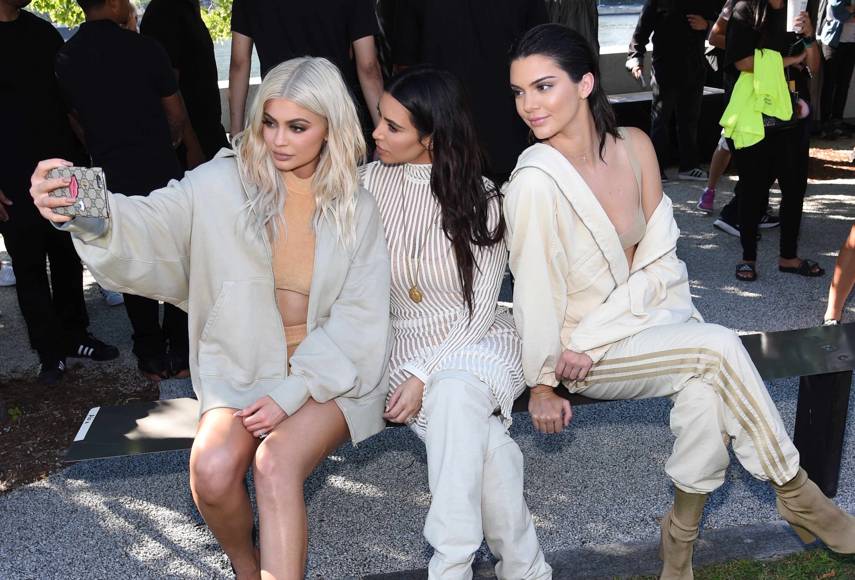 Kylie Jenner, Kim Kardashian, and Kendall Jenner taking selfies at Yeezy Season 4 fashion show