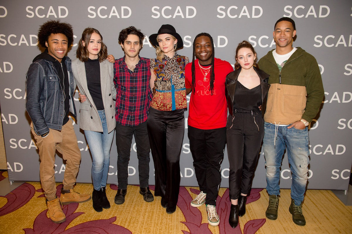 The 'Legacies' cast stands side-by-side and poses | Marcus Ingram/Getty Images