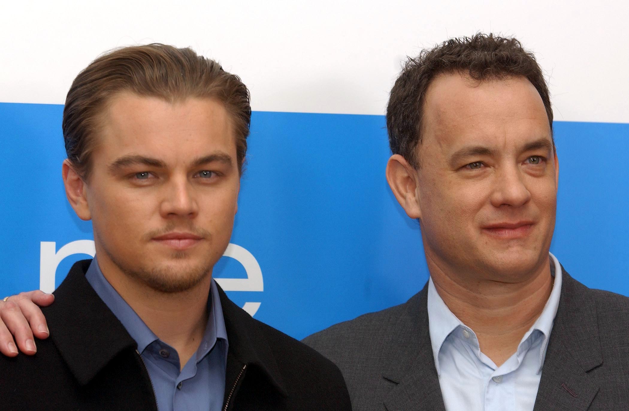 Leonardo DiCaprio stands with Tom Hanks at the Catch Me If You Can press conference