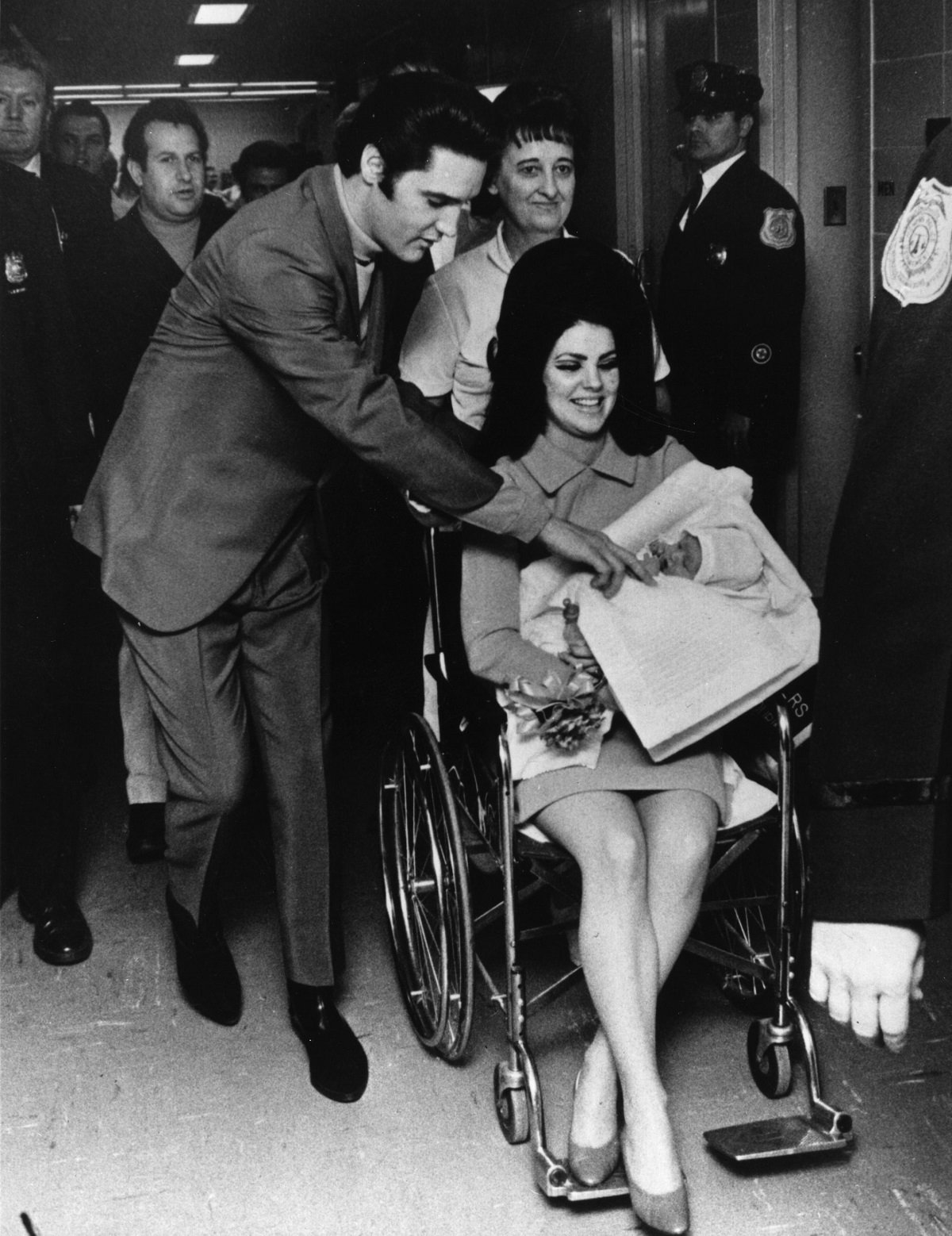 Elvis Presley and Priscilla Presley leaving the Baptist Hospital in Memphis with baby Lisa Marie Presley