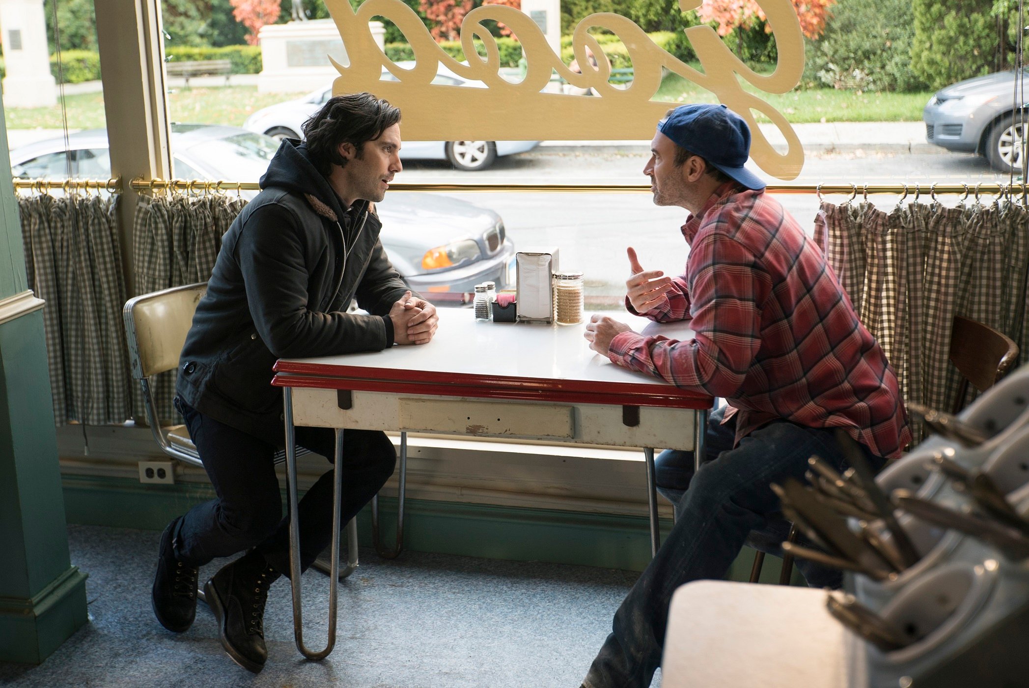 Jess Mariano and Luke Danes sit in the window of Luke's Diner in 'Gilmore Girls: A Year in the Life'