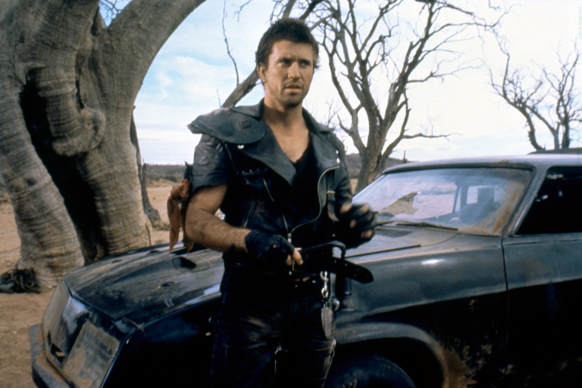 Mad Max: Mel Gibson stands next to Max's car