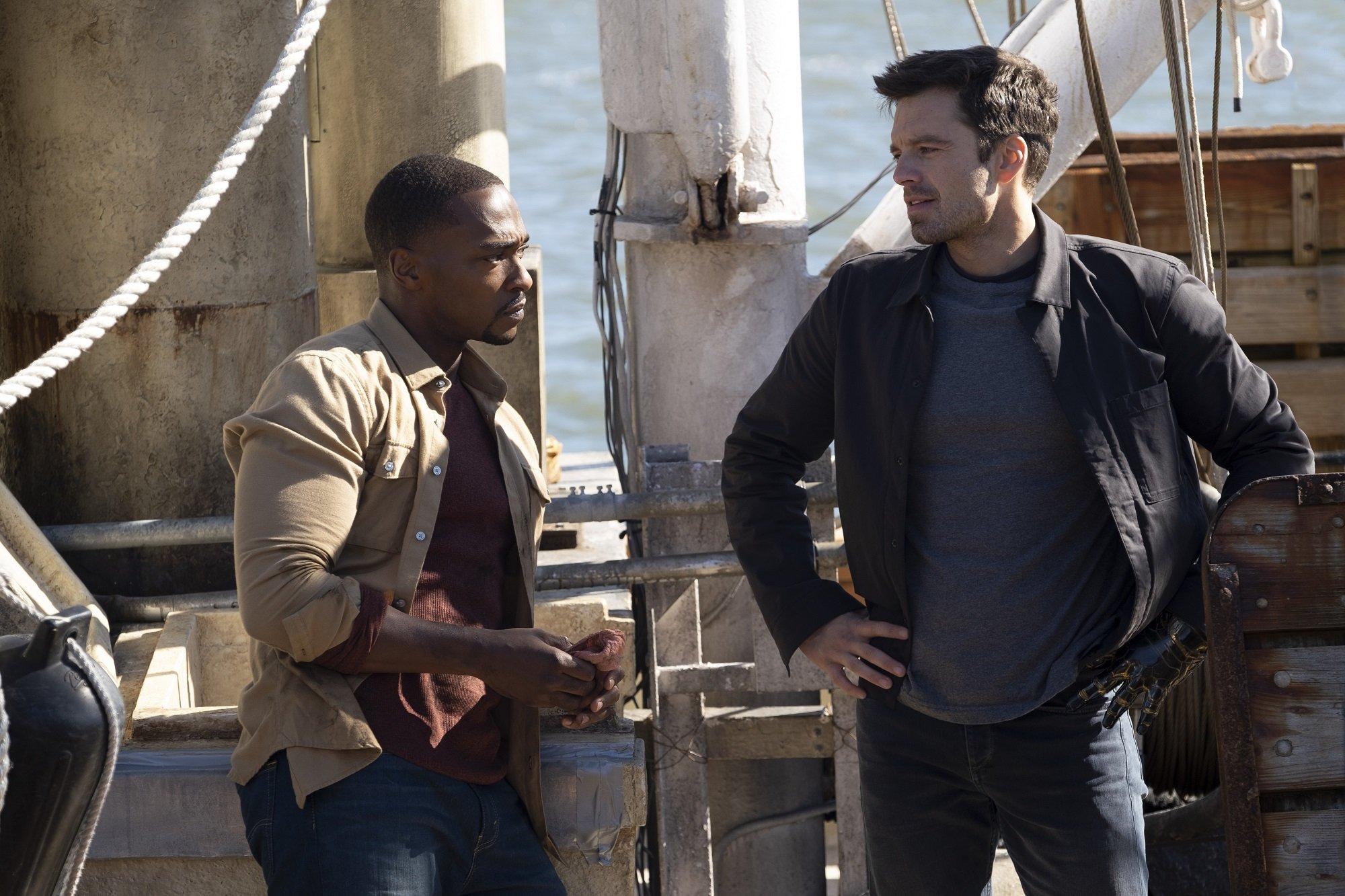 Marvel heroes Sam Wilson and Bucky Barnes talk on a pier