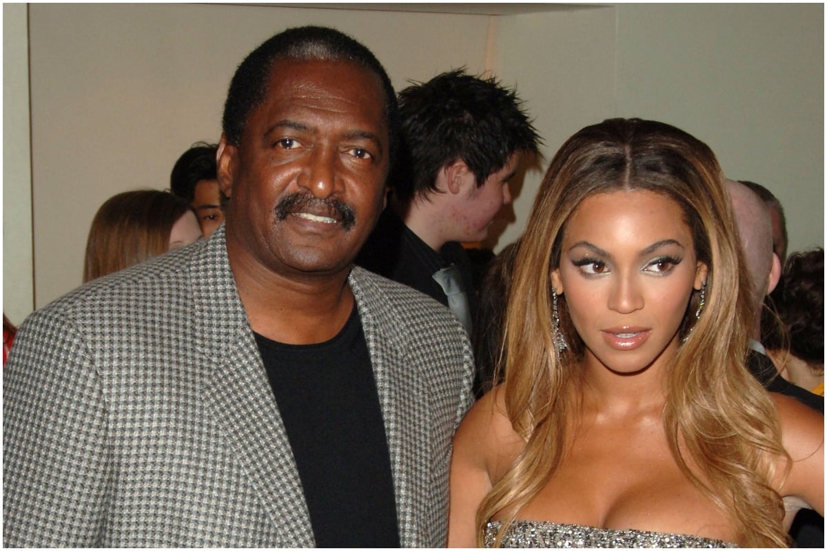 Mathew Knowles and Beyonce pose at an event.