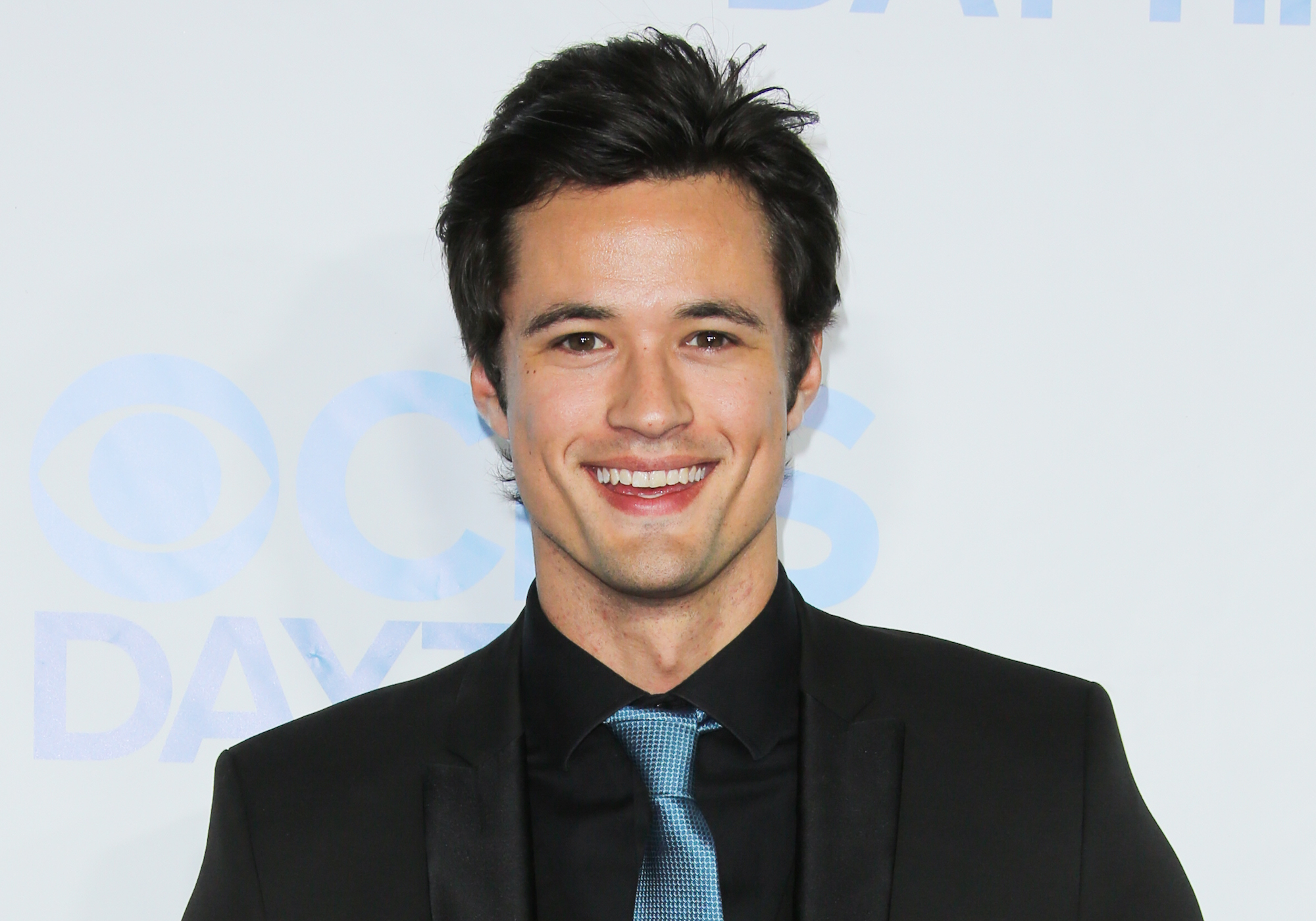 Matthew Atkinson smiling in front of a white background