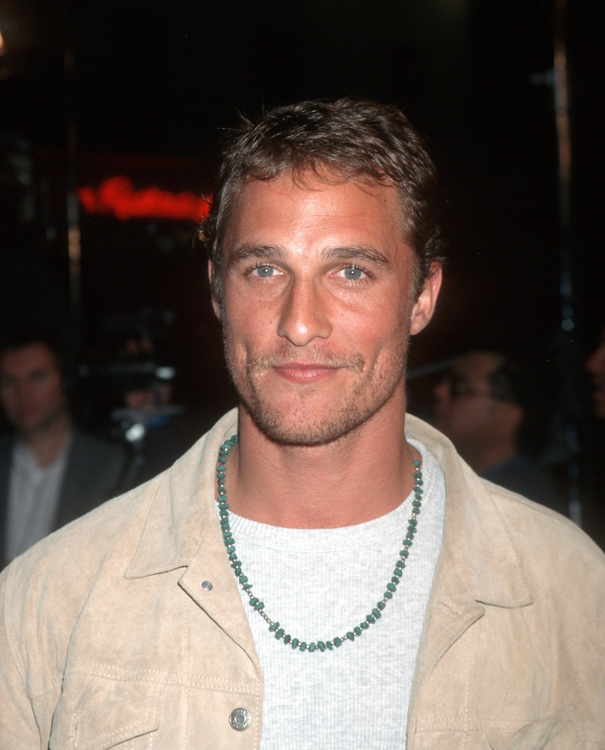 Matthew McConaughey wearing a blue necklace