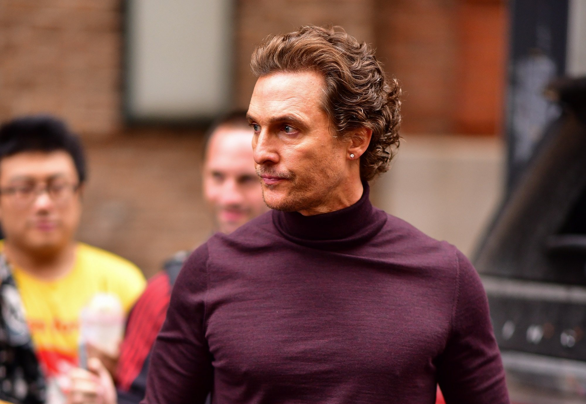 Matthew McConaughey in a purple shirt outside