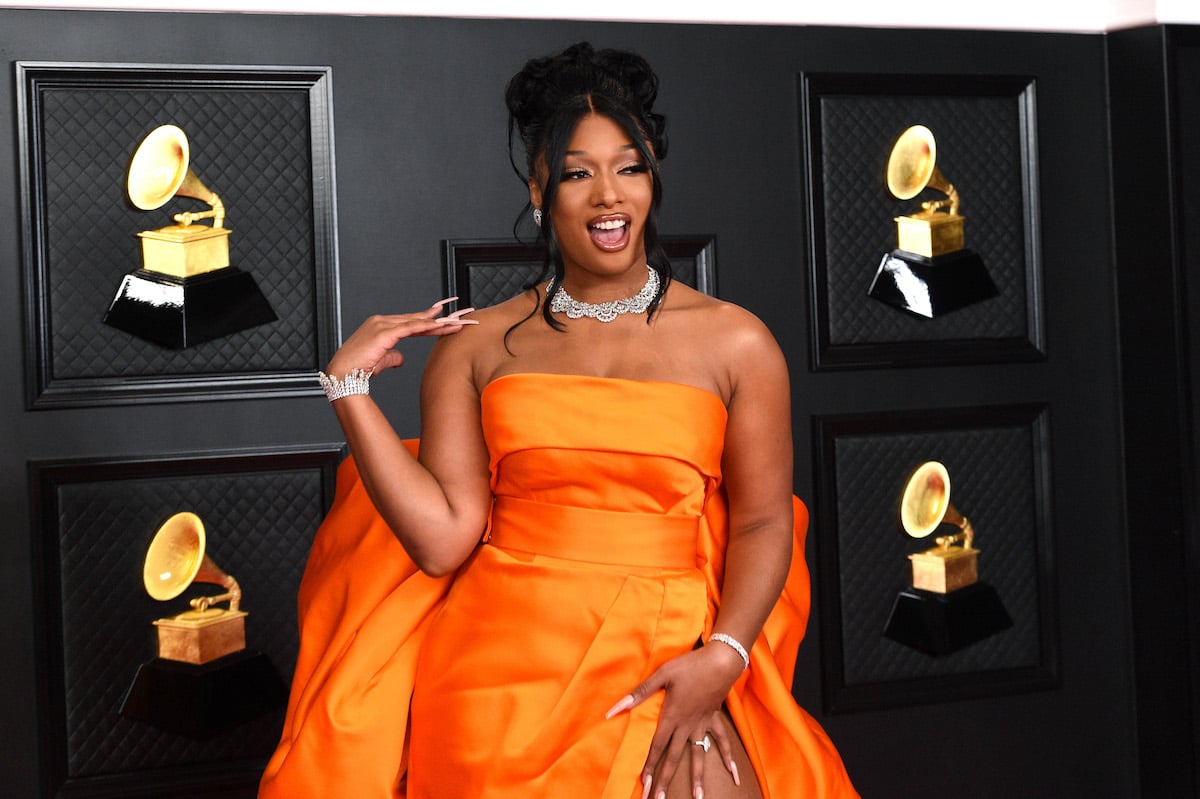 Megan Thee Stallion attends the 63rd Annual GRAMMY Awards in a orange gown