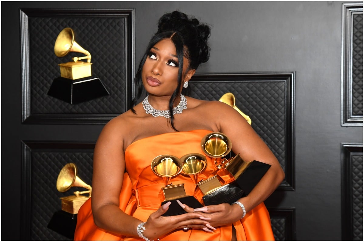 Megan Thee Stallion holding her trophies at the 2021 Grammy Awards.