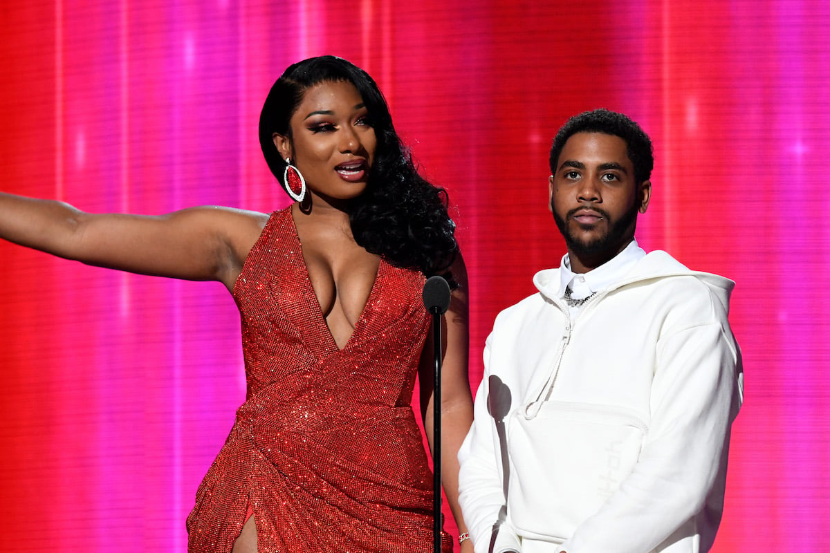 Megan Thee Stallion stands next to shorter Jharrel Jerome on stage
