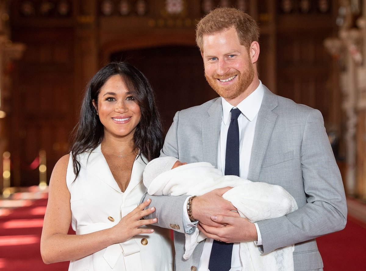 Britain's Prince Harry, Duke of Sussex, and his wife Meghan, Duchess of Sussex, pose for a photo with their newborn baby son, Archie Harrison Mountbatten-Windsor, in St George's Hall at Windsor Castle in Windsor, west of London on May 8, 2019.