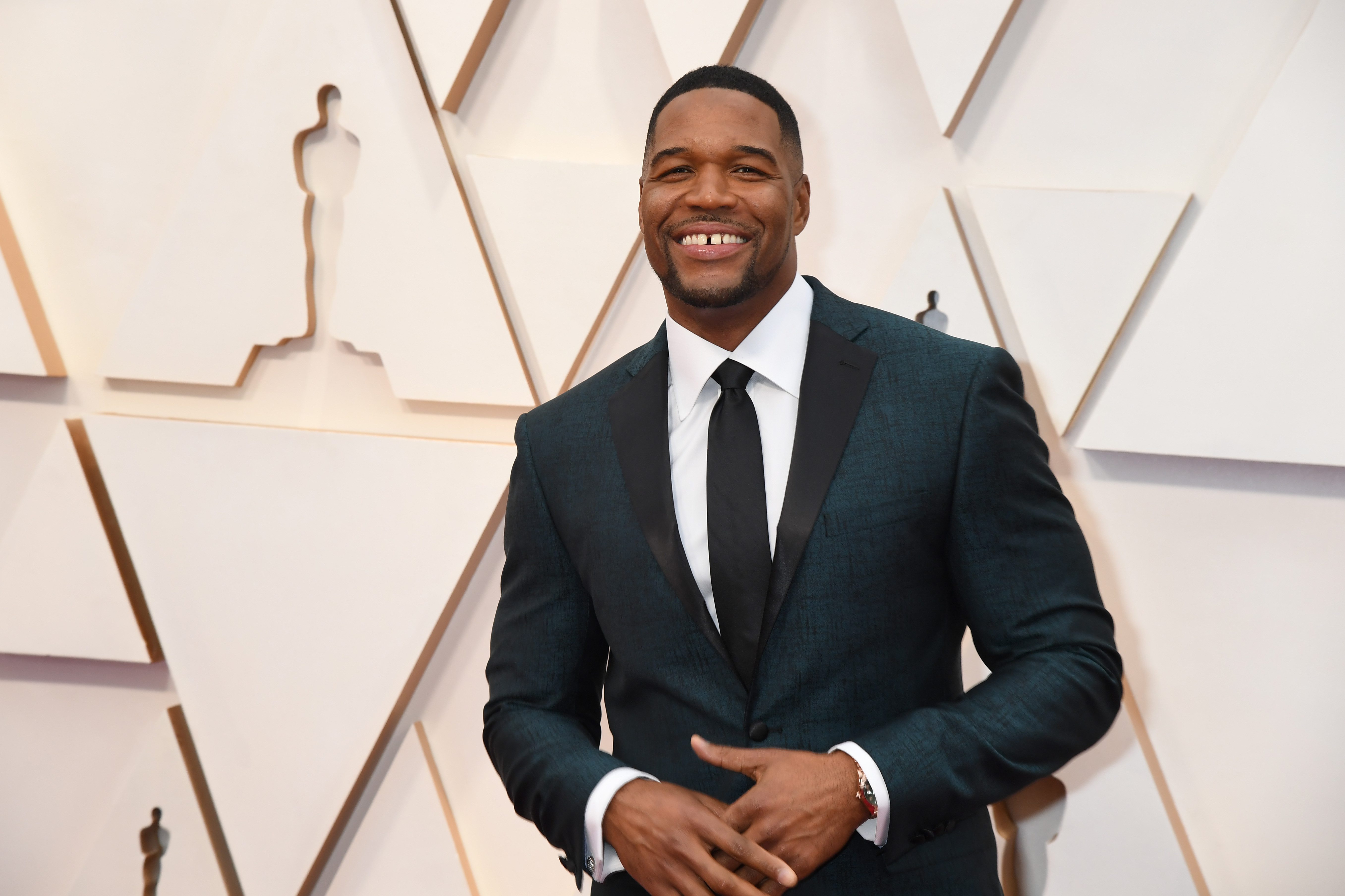 Michael Strahan of 'Good Morning America' smiles for cameras as he attends the 92nd Annual Academy Awards at Hollywood and Highland