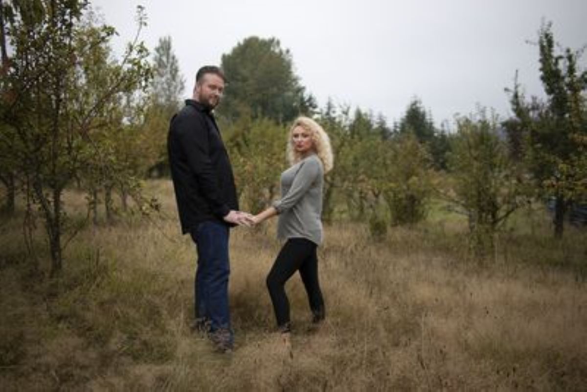 Mike and Natalie from '90 Day Fiancé' hold hands standing far apart.