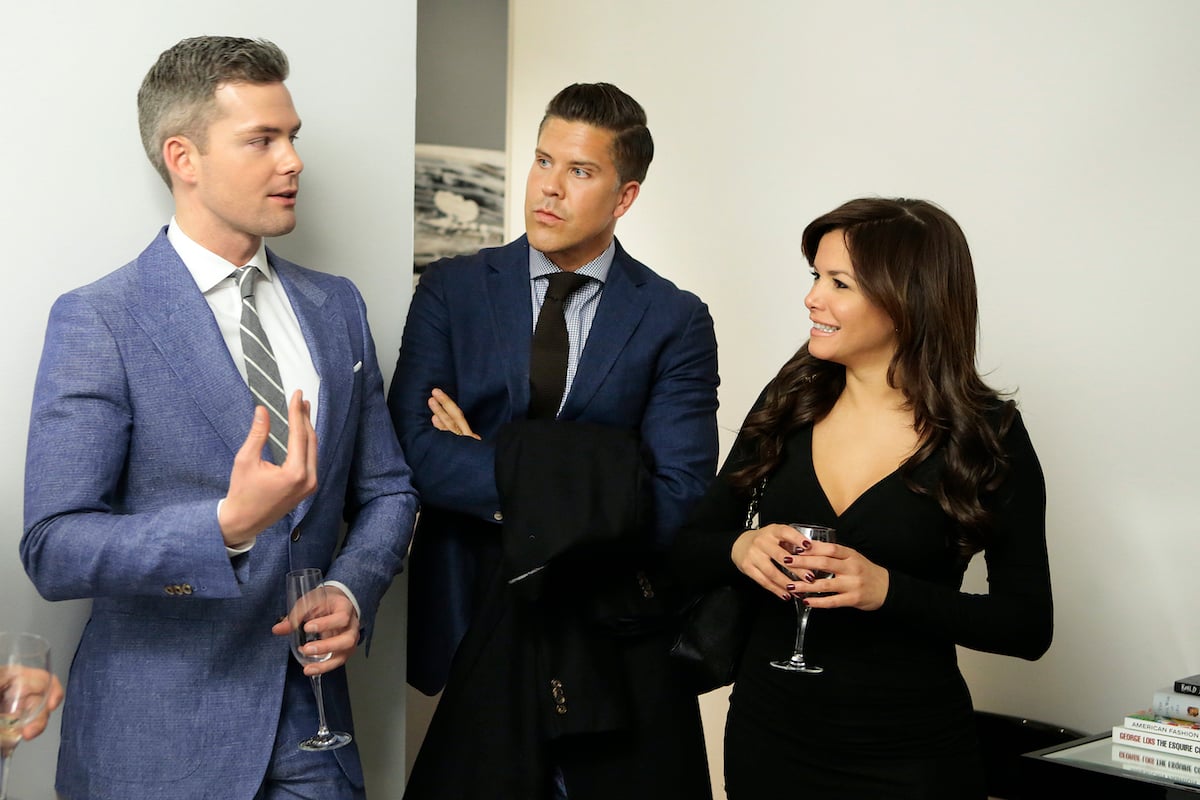 Ryan Serhant, Frederik Eklund discuss business with a client 