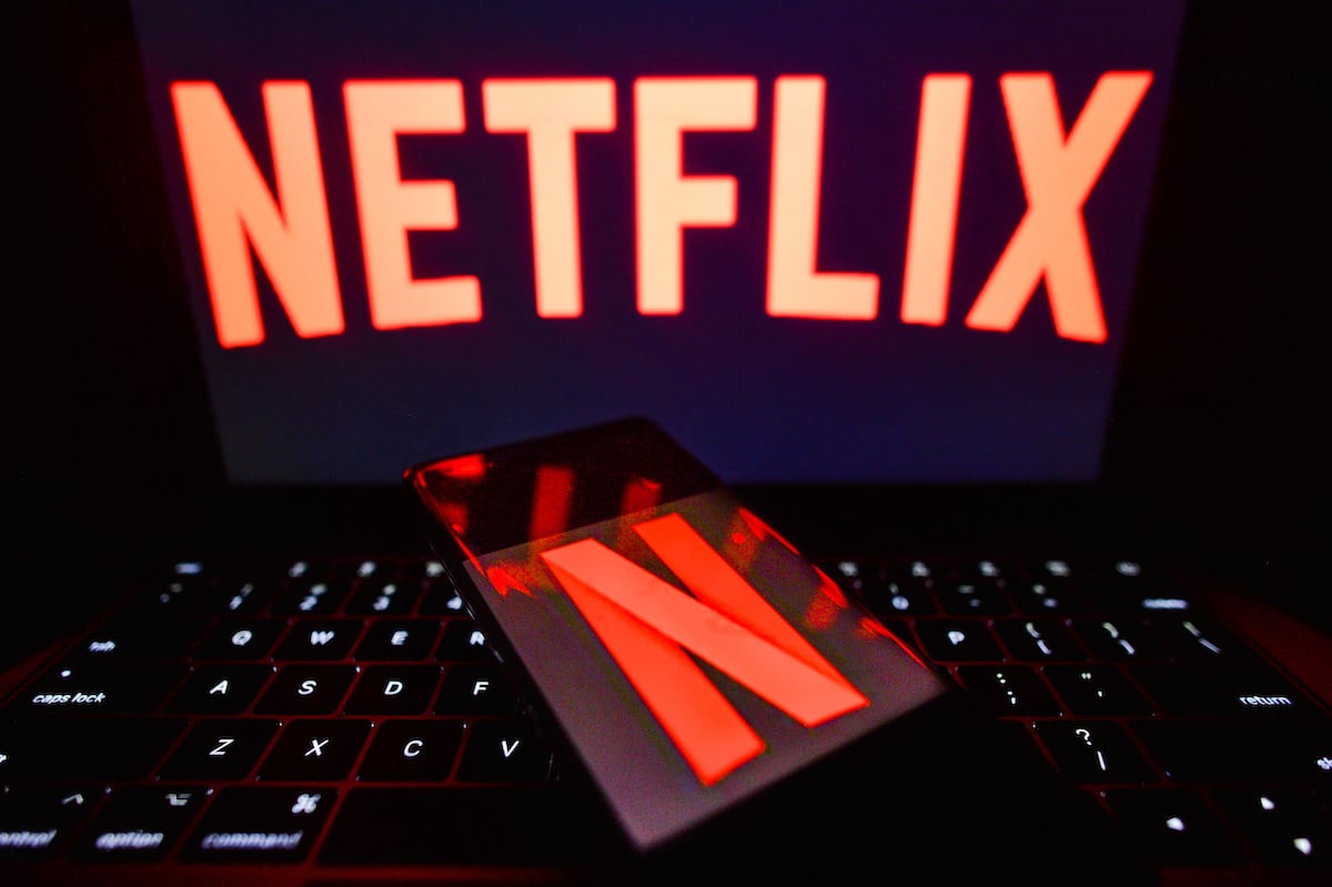 The Netflix logo on a smartphone and a computer screen