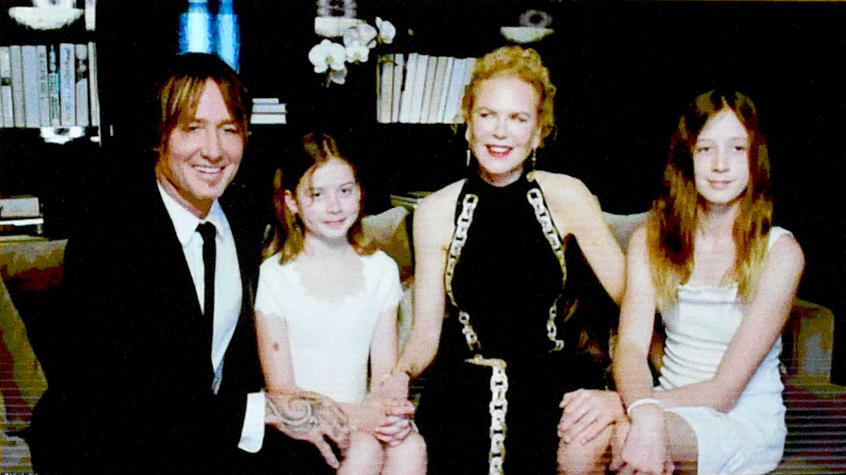 Nicole Kidman, Keith Urban, and their two daughters, Sunday Rose and Faith Margaret sit side-by-side on a couch via Zoom during an appearance at the 2021 Golden Globes
