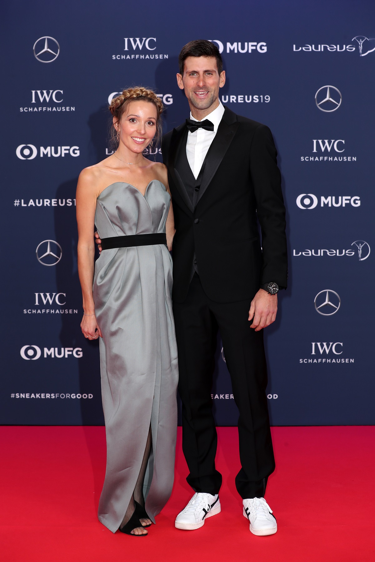 Novak Djokovic and wife Jelena Djokovic smile and pose together on red carpet at Laureus World Sports Awards