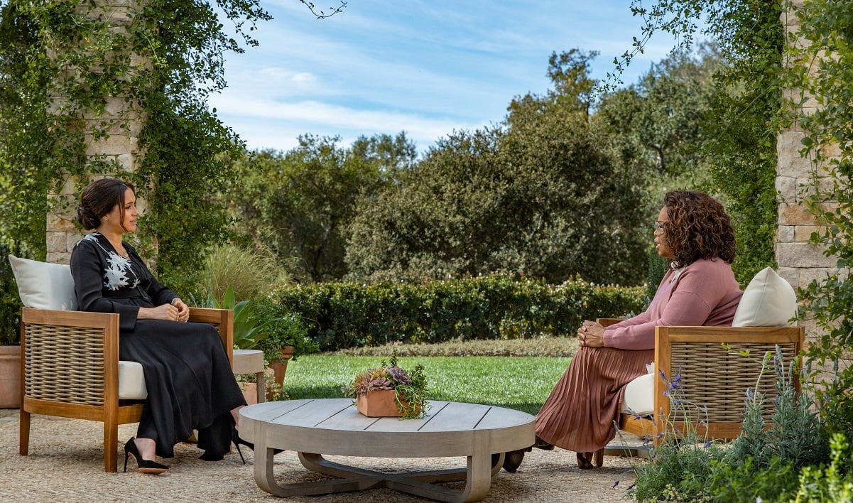 Oprah Winfrey interviewing Meghan Markle sitting outdoors