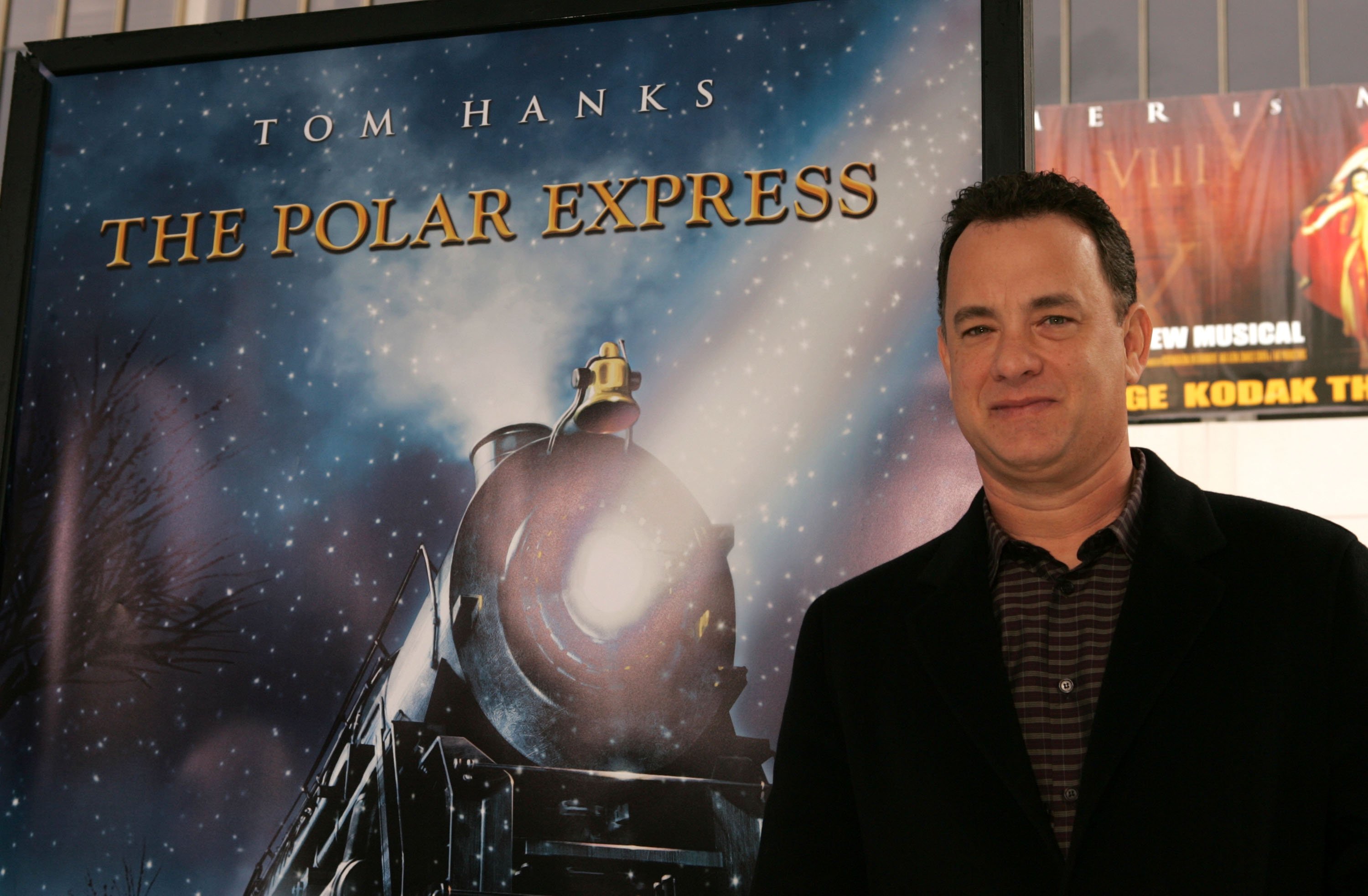 Polar Express star Tom Hanks in front of the poster