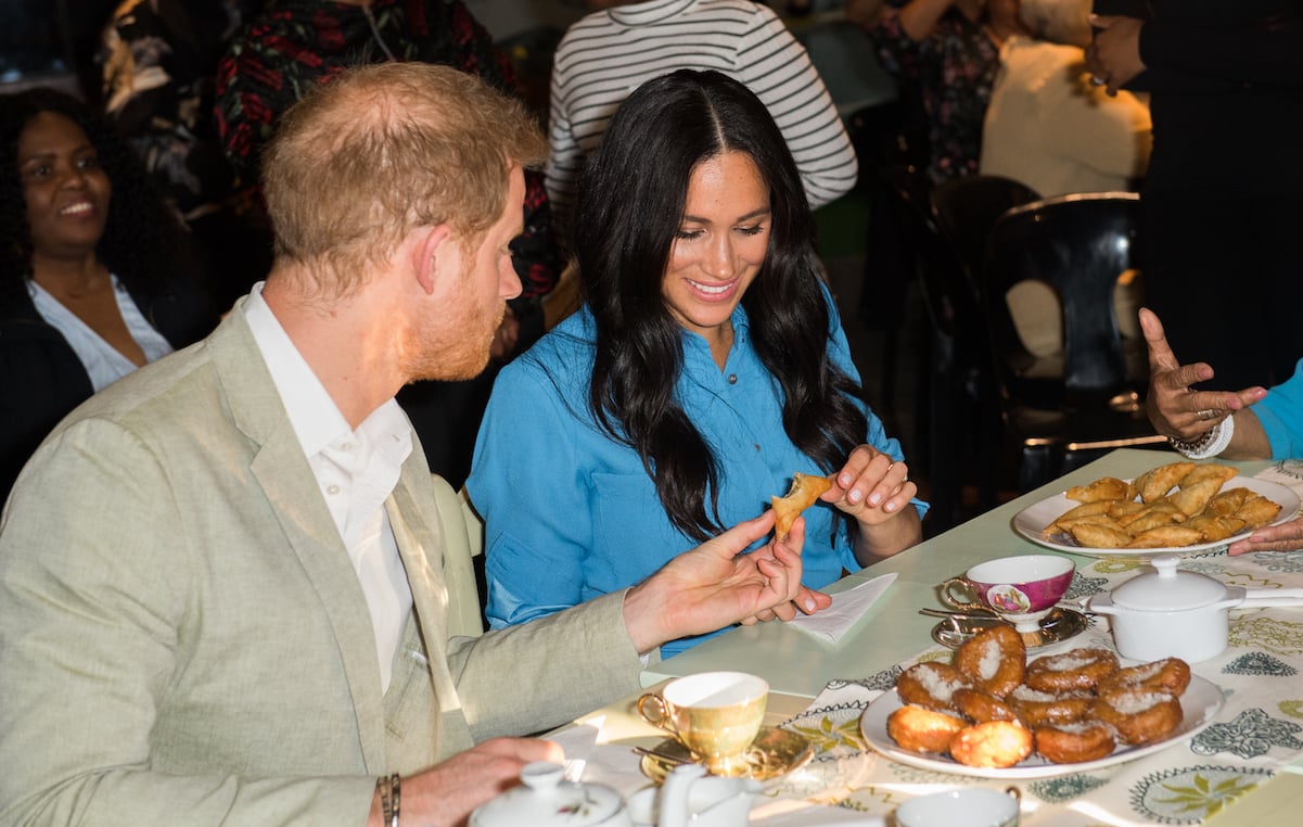Prince Harry and Meghan Markle sample food in South Africa in 2019