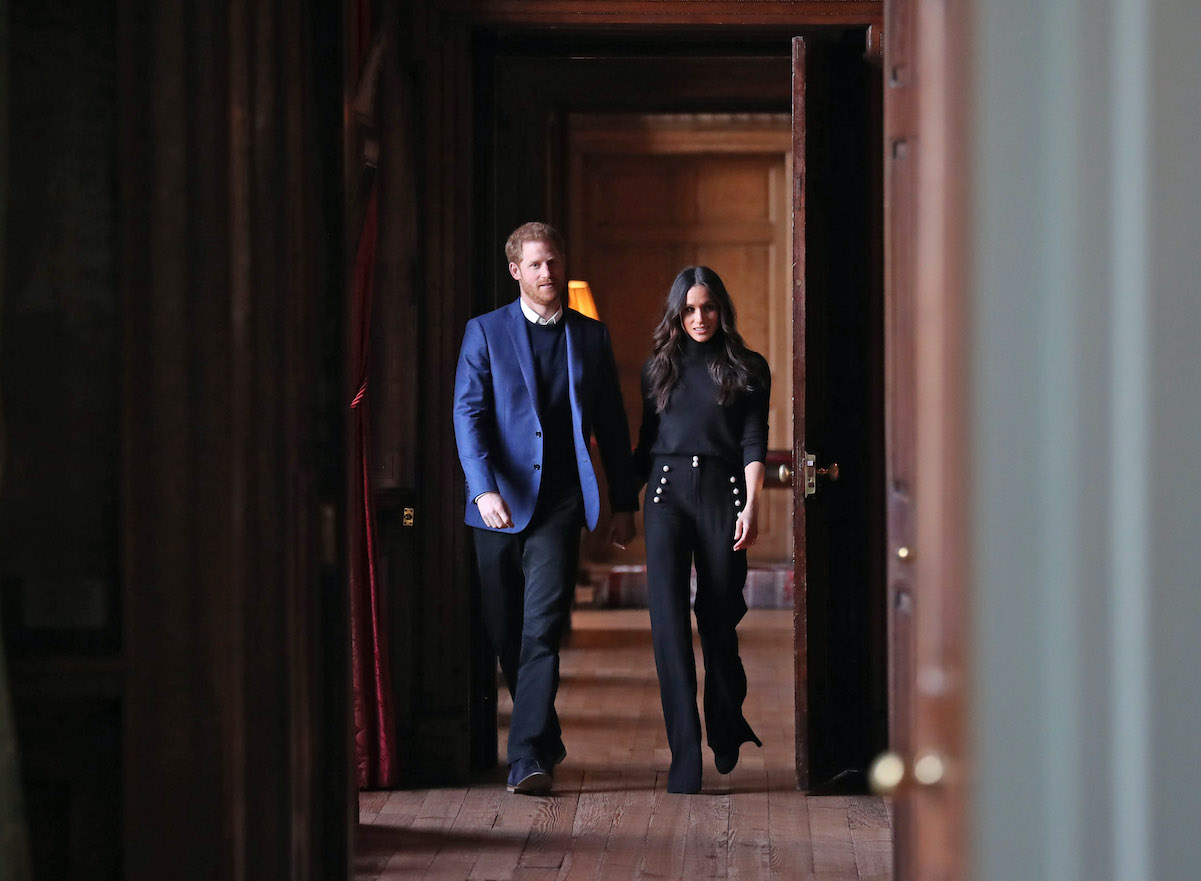 Prince Harry and Meghan Markle in the corridors of the Palace of Holyroodhouse in Edinburgh, Scotland in 2018.