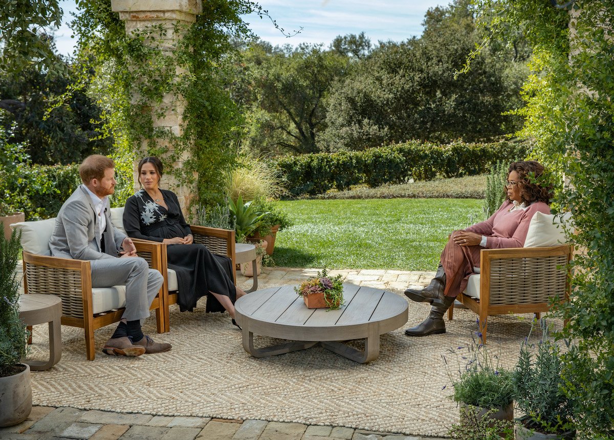 Prince Harry and Meghan Markle sit outside during their interview with Oprah