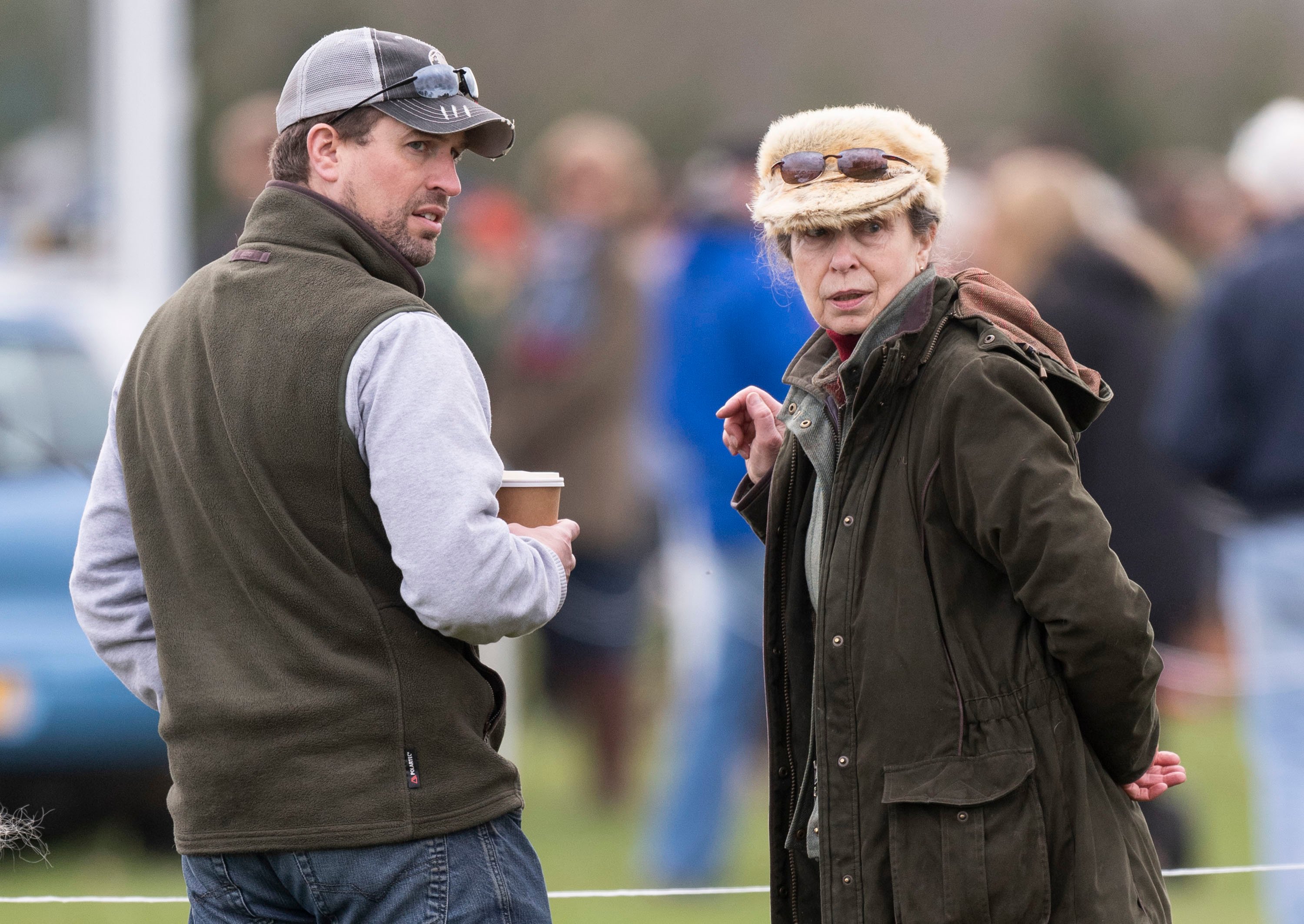 Peter Phillips standing with his mother, Princess Anne, at looking back over his shoulder the Land Rover Novice & Intermediate Horse Trials