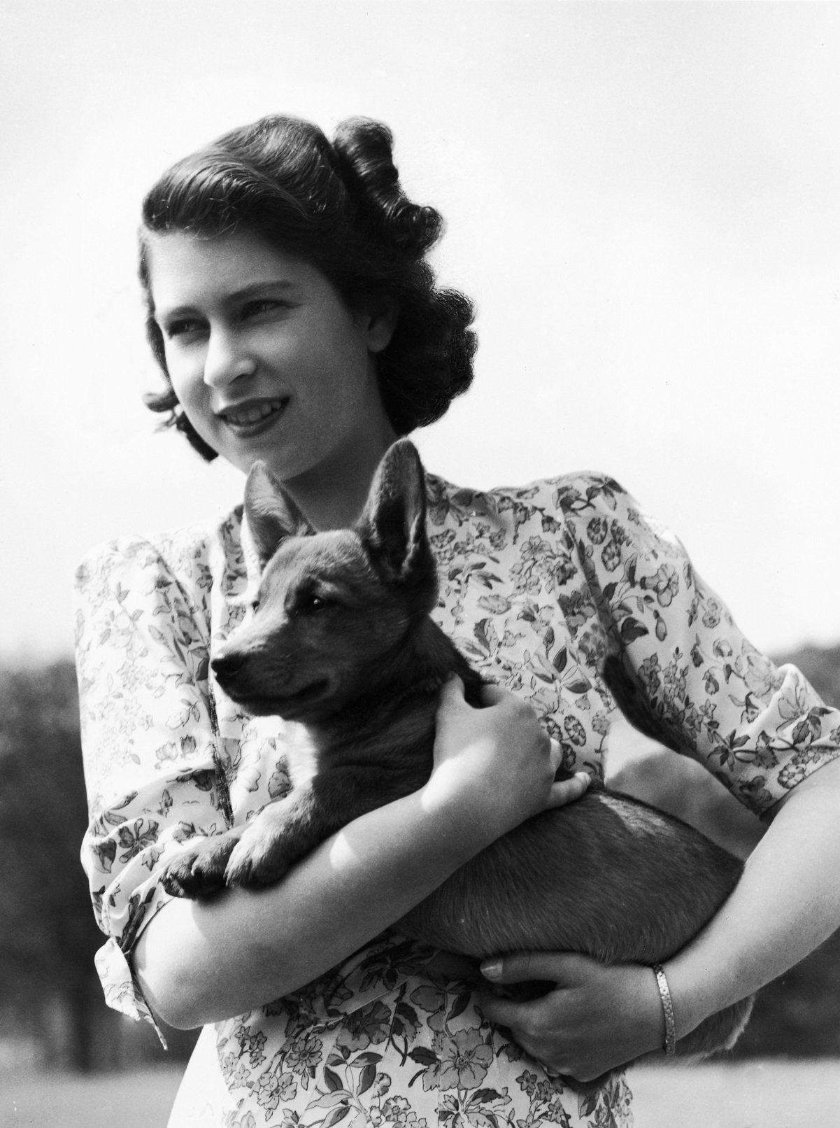 Princess Elizabeth holding her corgi pup Sue in 1944