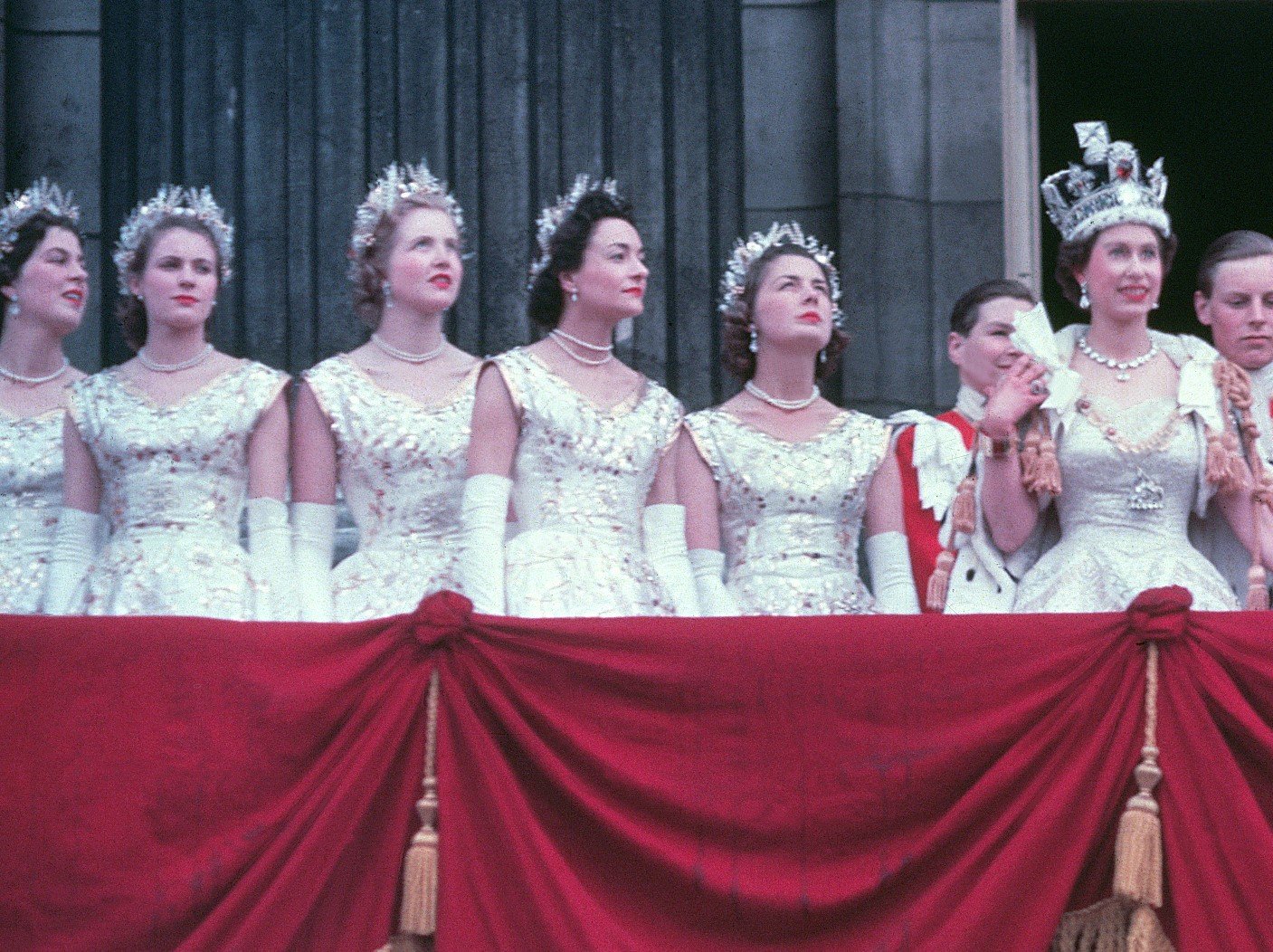 Queen Elizabeth II standing on the balcony of Buckingham Palace with several women by her side following her Coronation