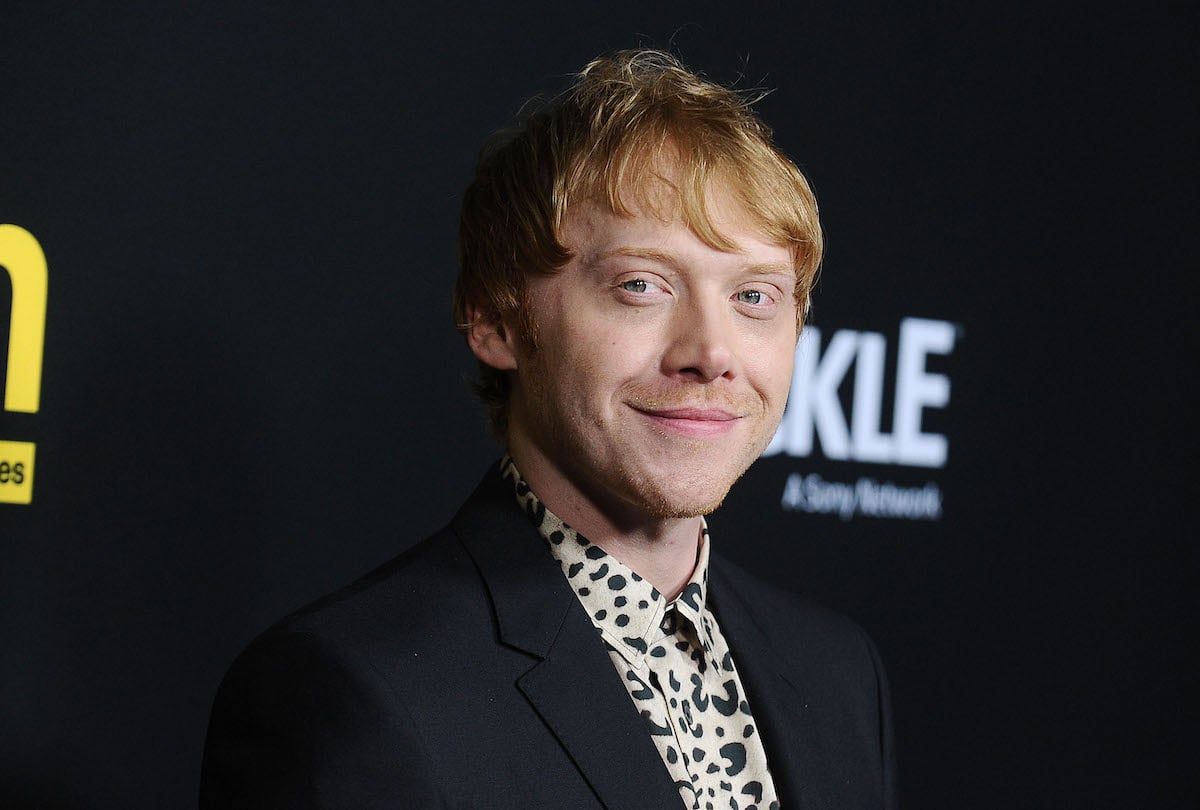 Rupert Grint smiles as he poses for cameras at the premiere screening of 'Snatch' in 2017