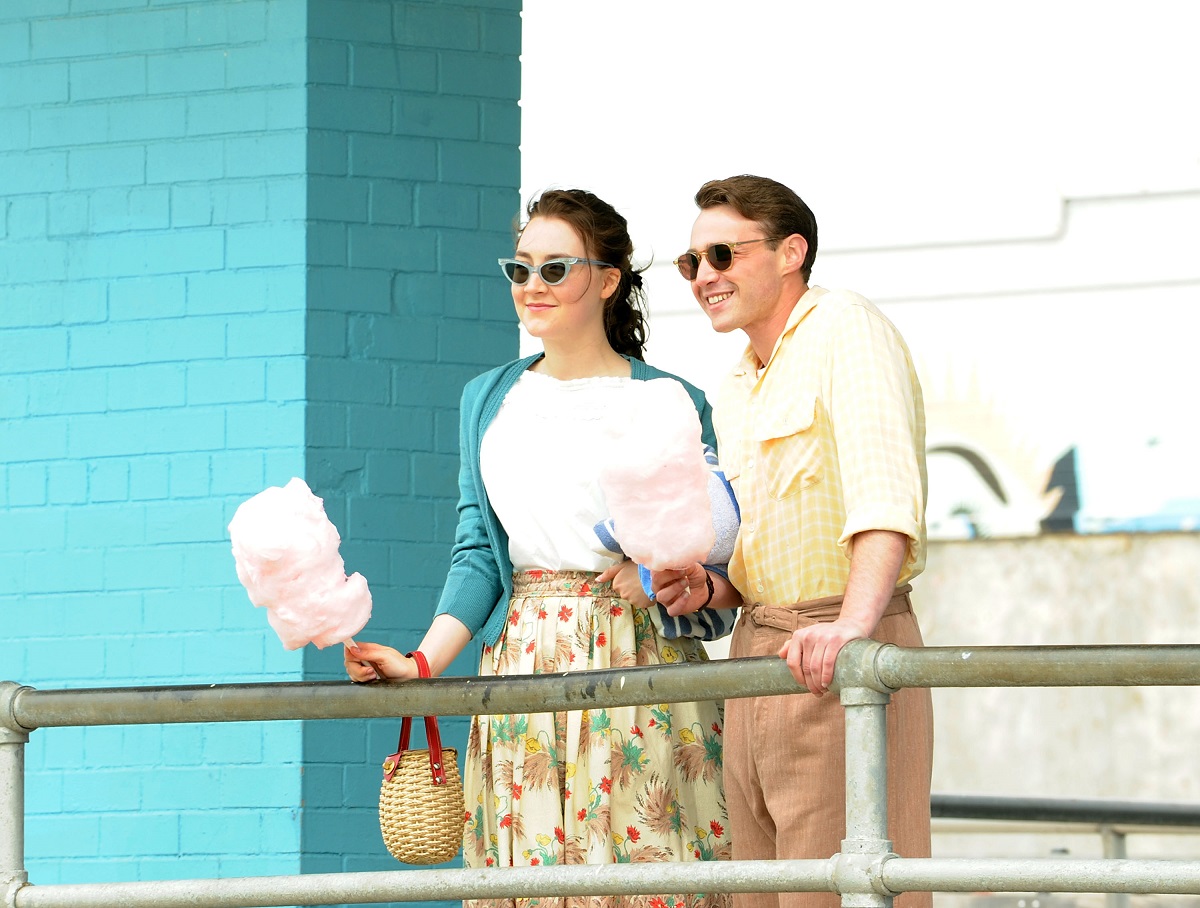 Saoirse Ronan and Emory Cohen holding cotton candy at Coney Island on the set of 'Brooklyn' 