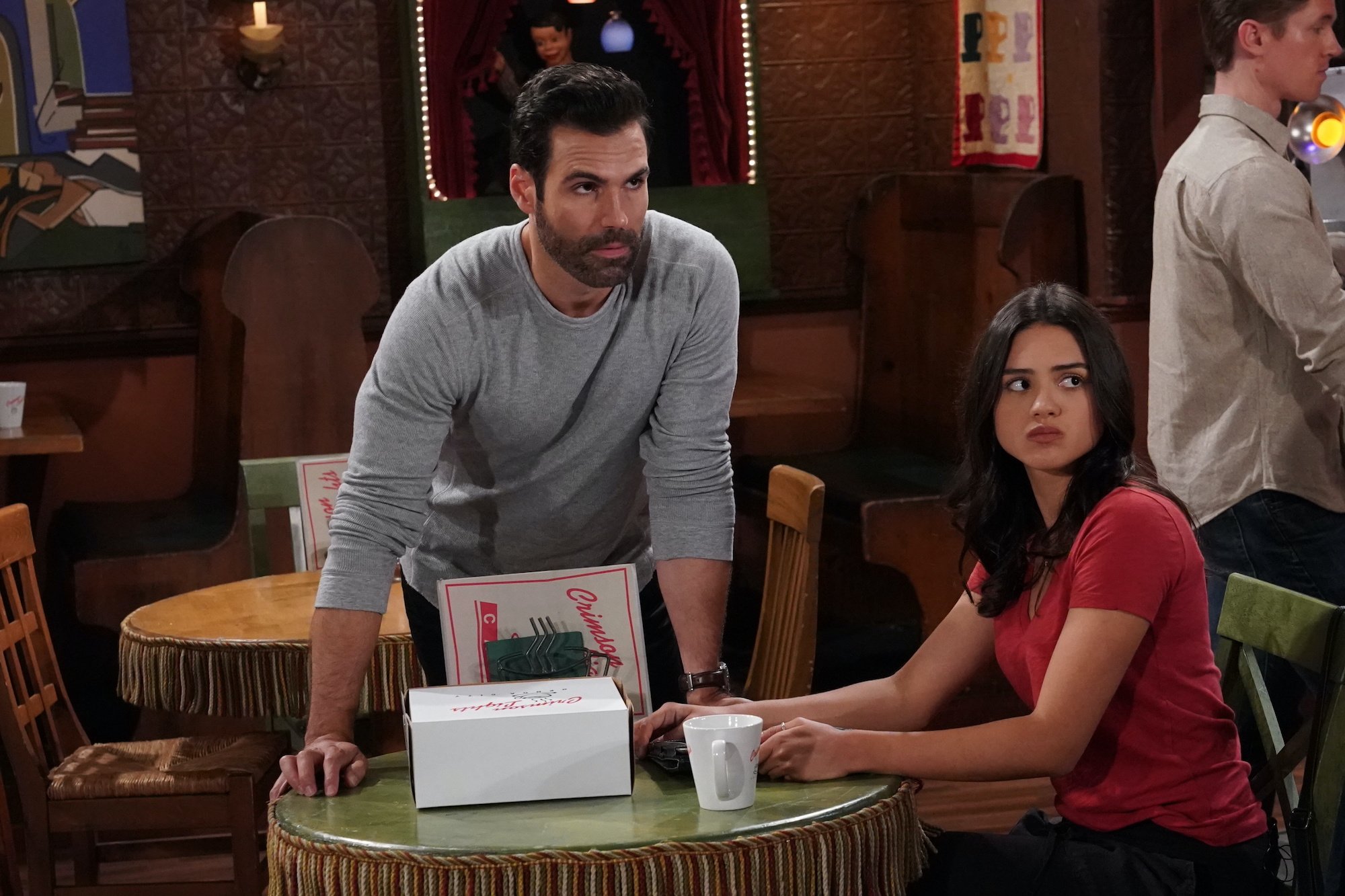 (L-R) Jordi Vilasuso and Sasha Calle sitting at a table on 'The Young and the Restless'