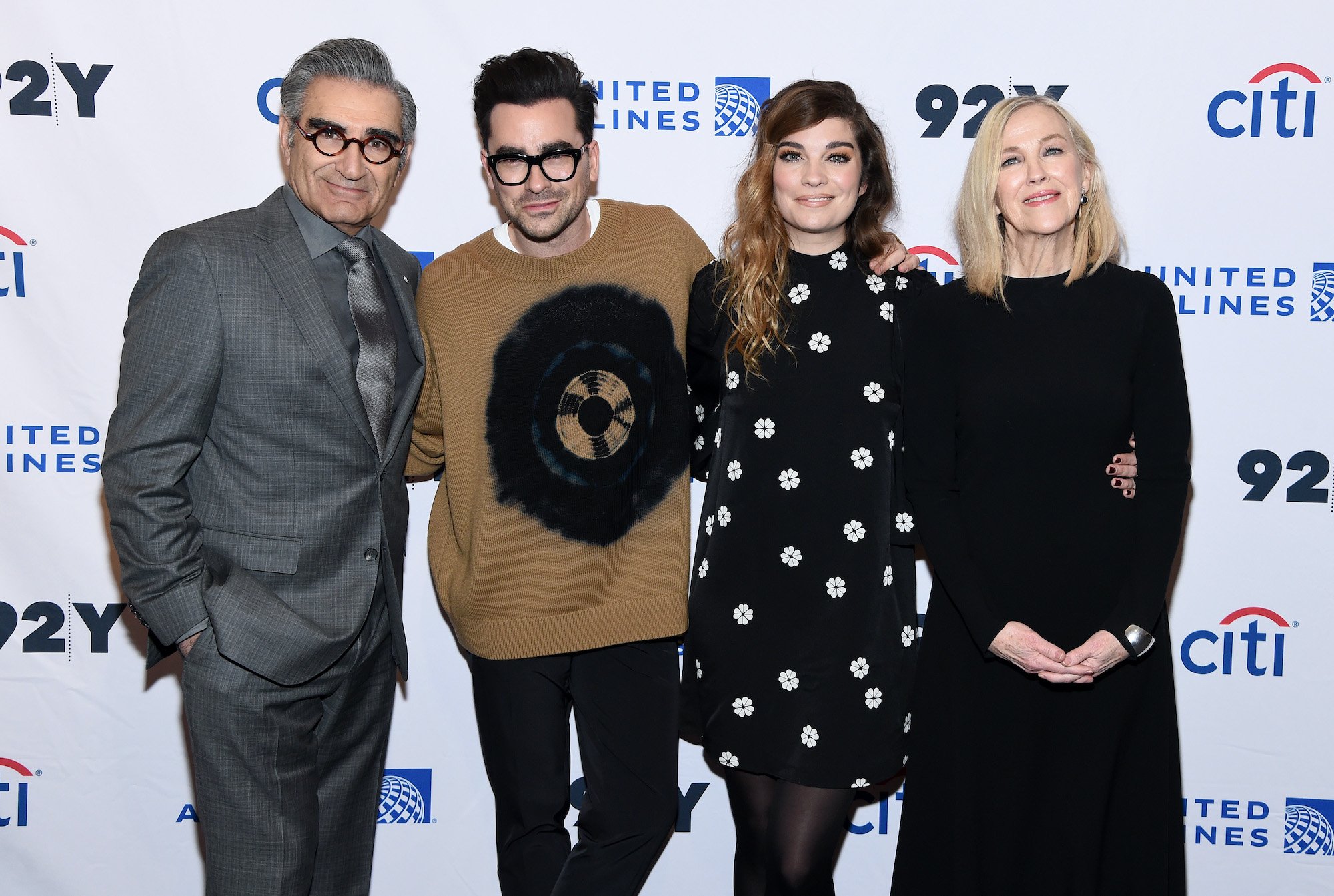 (L-R) Eugene Levy, Daniel Levy, Annie Murphy and Catherine O'Hara smiling in front of a white background