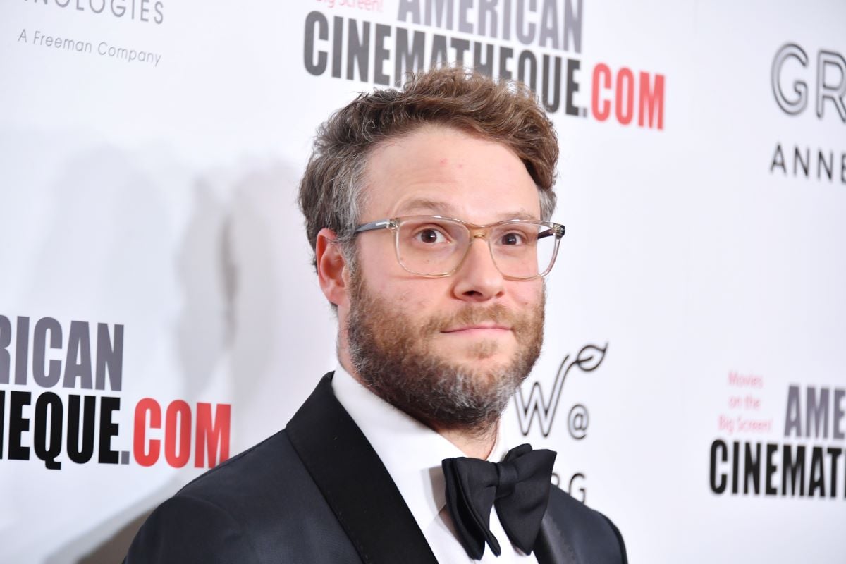 Seth Rogen poses on the red carpet in a suit and bowtie.
