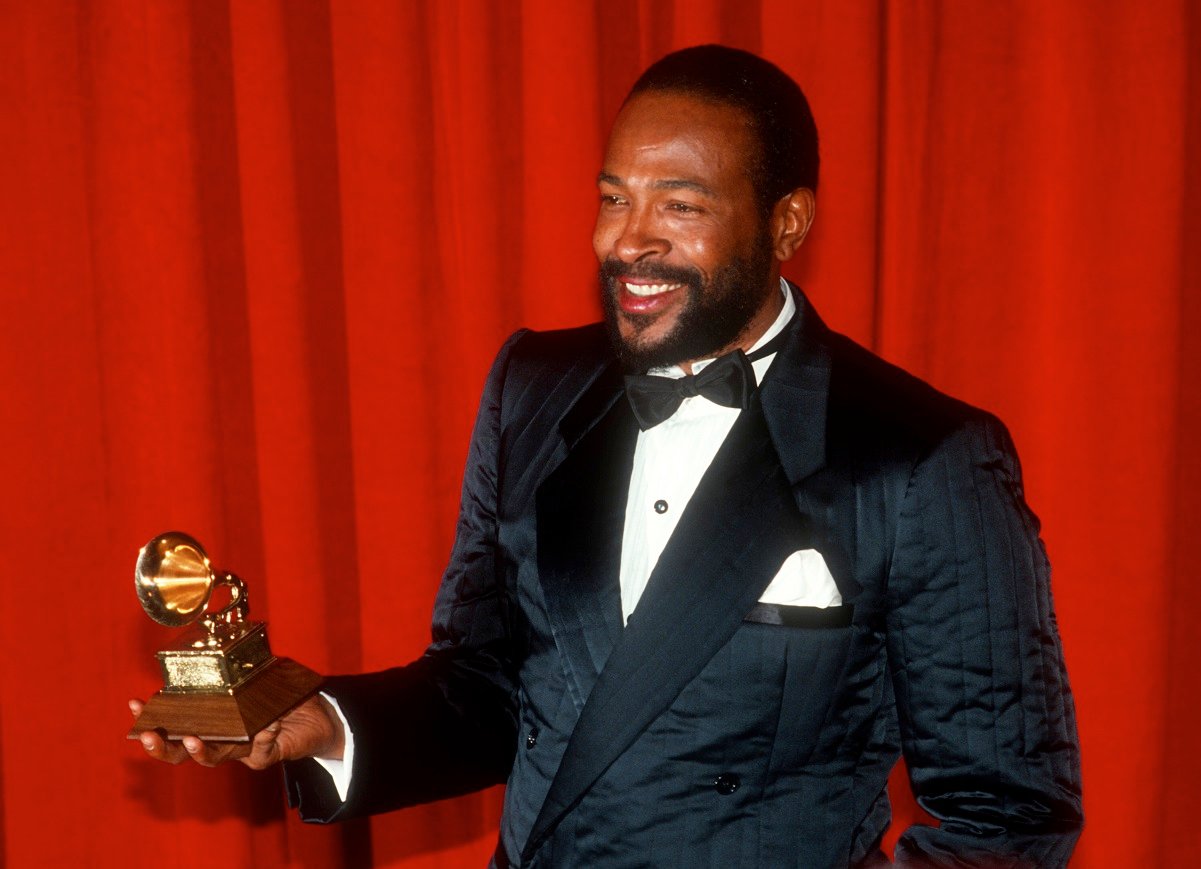 Singer Marvin Gaye holding his Grammy Award at a ceremony in 1983