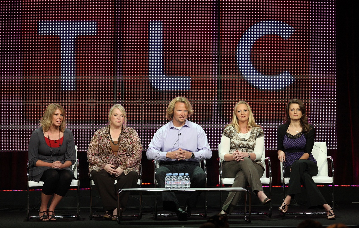 Meri, Janelle, Kody, Christine, and Robyn Brown of 'Sister Wives' sitting on a panel in front of a giant TLC logo during the Summer TCA Press Tour in 2010