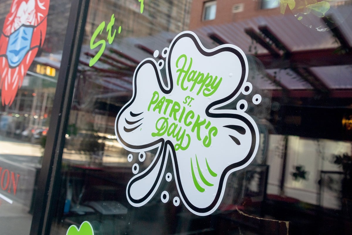 A Happy St. Patrick's Day shamrock sign on the window of the Red Lion Bar in New York City