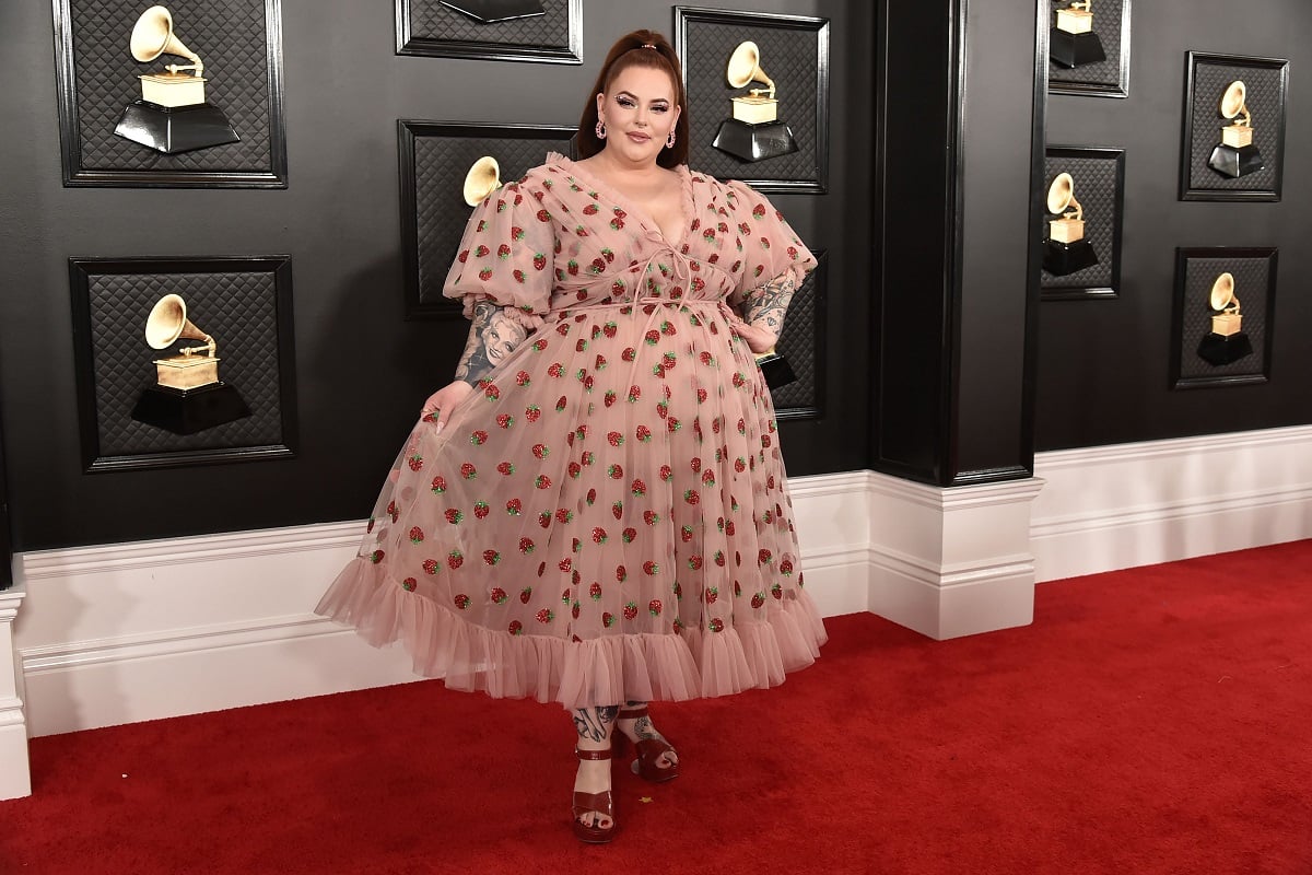 Tess Holliday attends the 62nd Annual Grammy Awards at Staples Center on January 26, 2020 in Los Angeles, CA, in Lirika Matoshi's Strawberry Midi Dress on the red carpet.