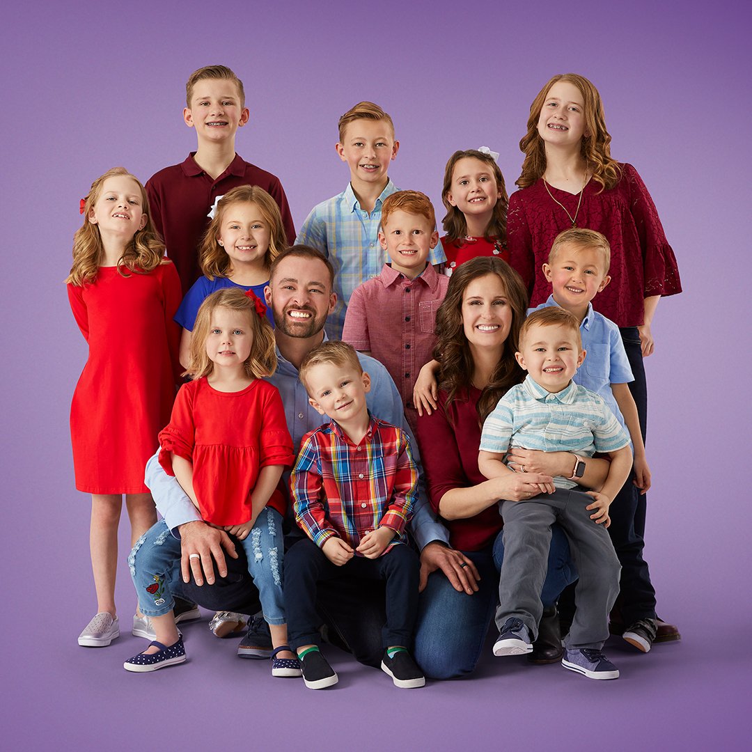 Portrait of Spencer and Erica Shemwell and their 11 kids on purple background