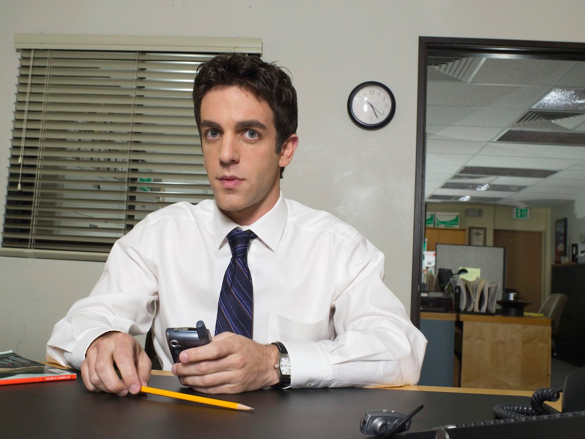 B.J. Novak as Ryan Howard sits at a desk looking at the camera on 'The Office'
