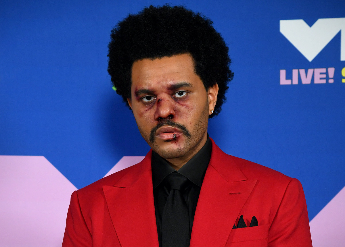 The Weeknd in a red suit and black shirt with fake bruises on his face as he arrives at the 2020 MTV Video Music Awards on August 30, 2020 | Kevin Mazur/MTV VMAs 2020/Getty Images for MTV