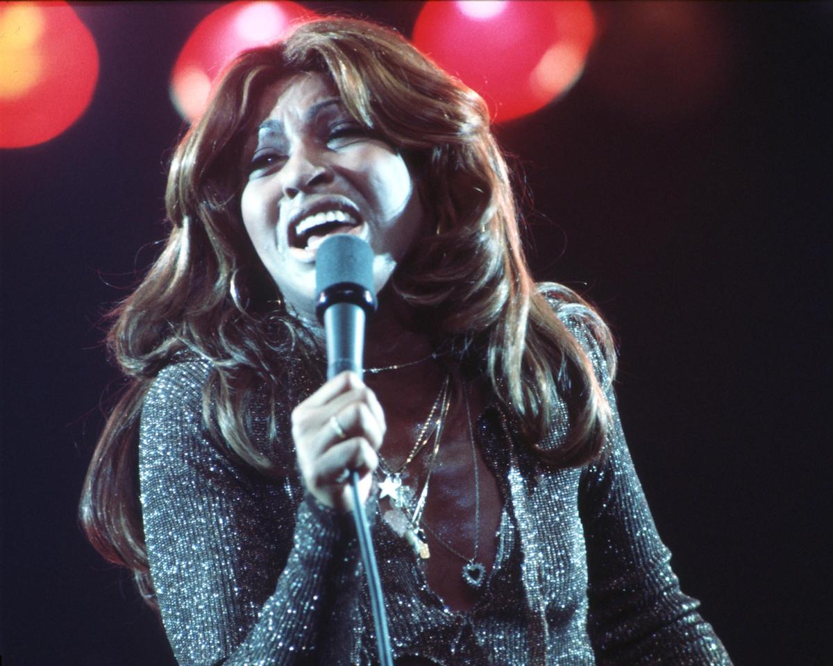 Tina Turner with long brown hair performing in a silver, glittering bodysuit on ‘Don Kirshner's Rock Concert’ in 1976