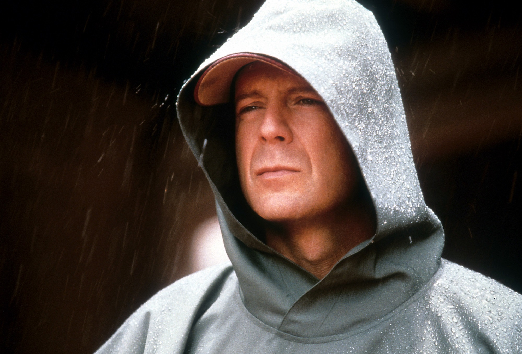 Unbreakable star Bruce Willis wearing a hood