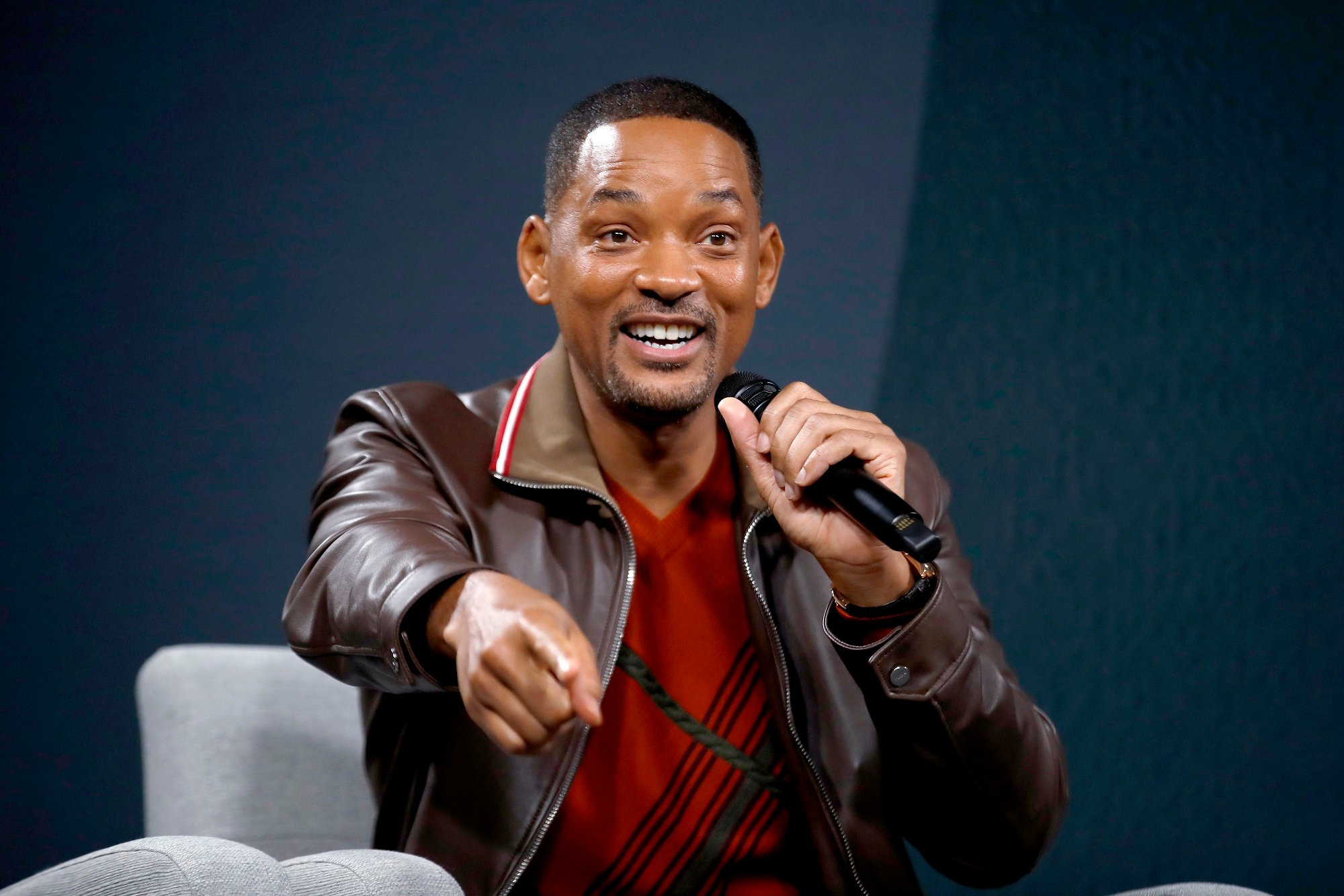 Will Smith sitting in a chair and pointing